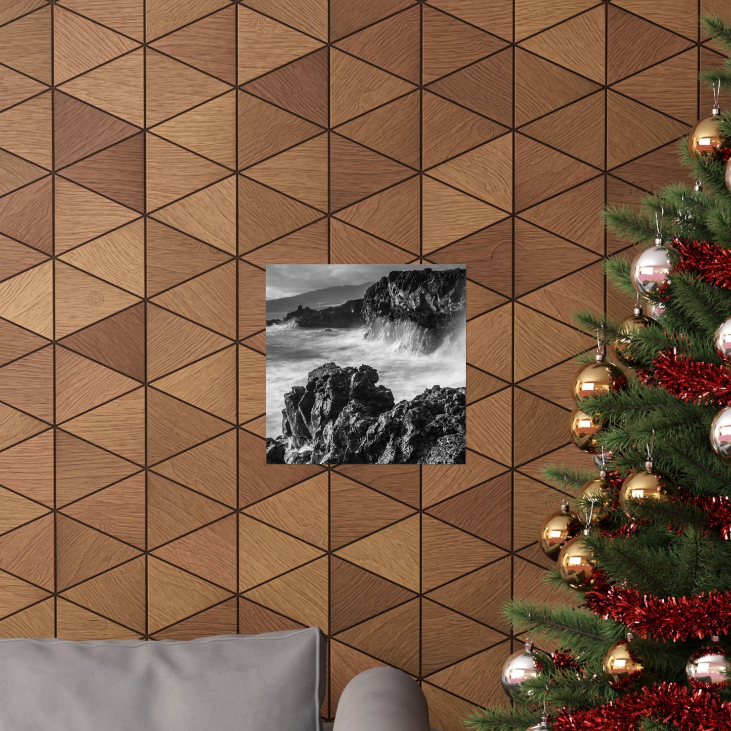 Wooden wall with geometric pattern, framed black and white photo, and decorated Christmas tree.