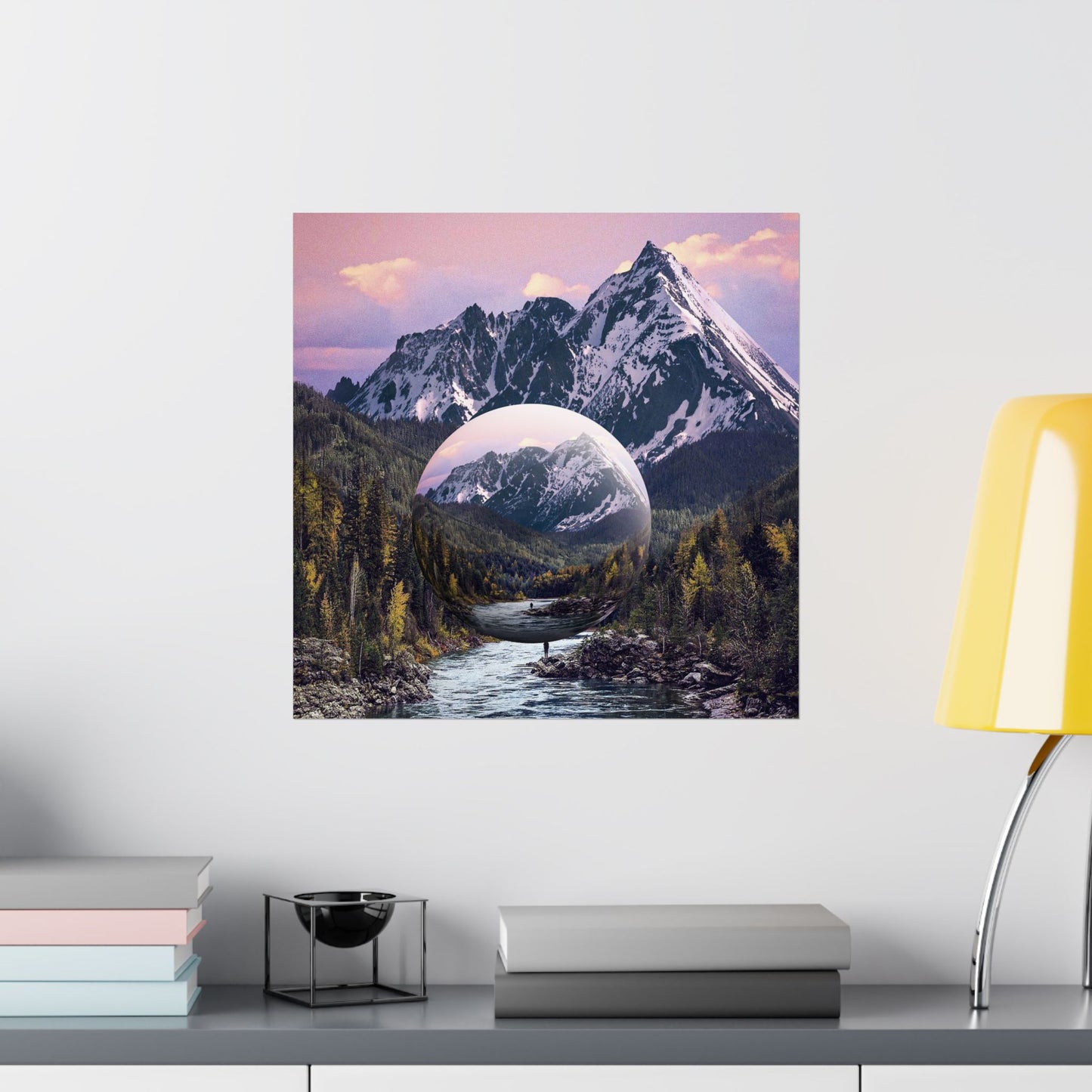Framed artwork of a mountain landscape with a reflective lake on a wall above a shelf.