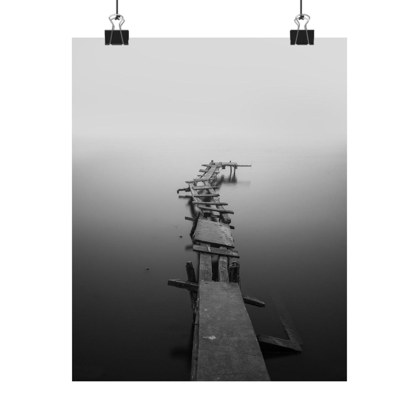 Wooden pier extending into a foggy body of water