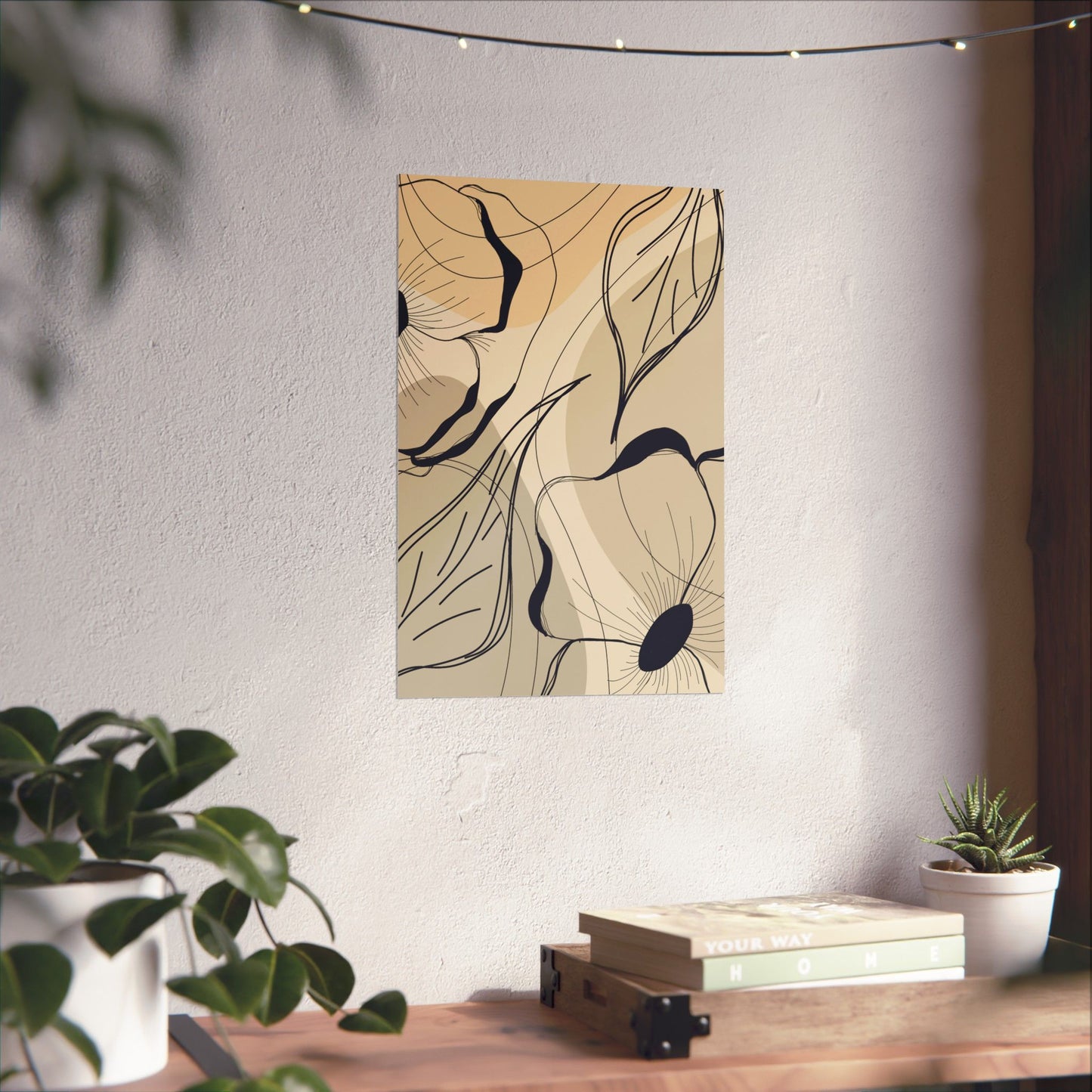 Abstract wall art on a white wall with a wooden table and plants in the foreground