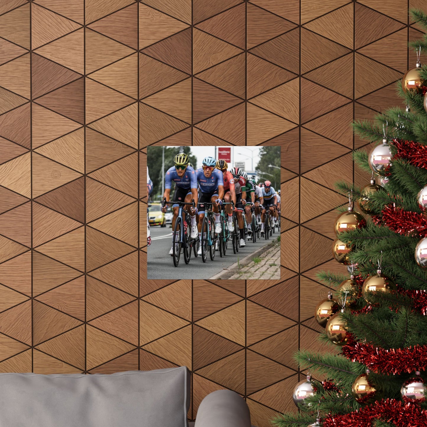 Wooden wall with geometric pattern, inset photo of cyclists, and Christmas tree with decorations.