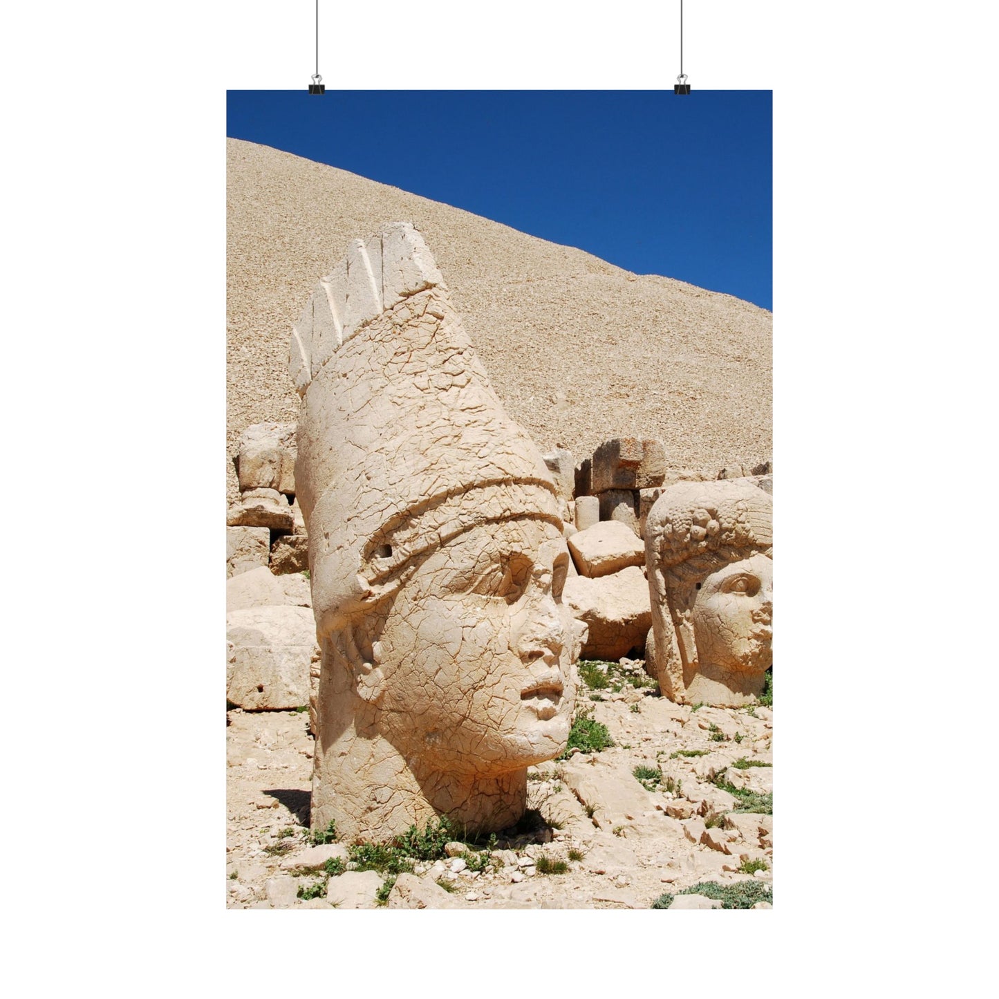 Stone head sculpture on a mountain with clear blue sky