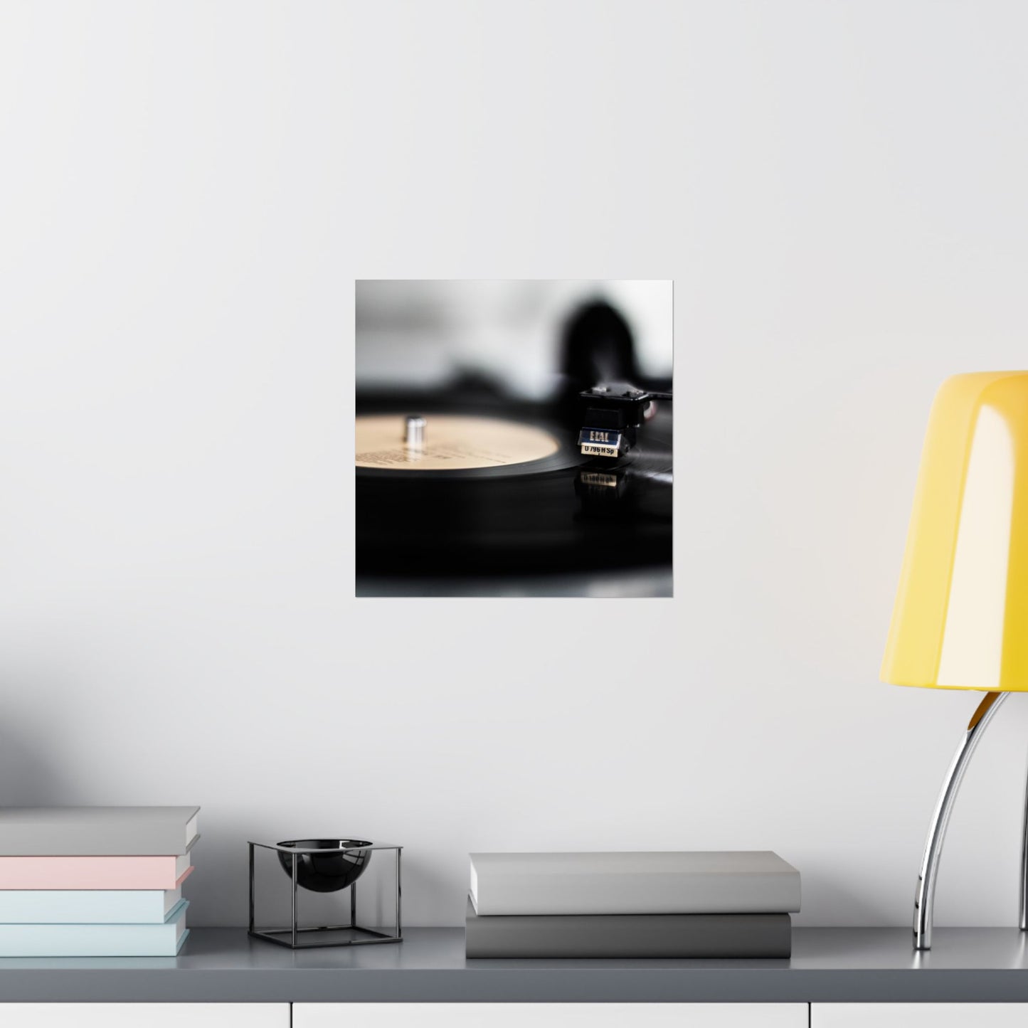 Modern interior with a yellow lamp, books, and decorative items on a shelf.