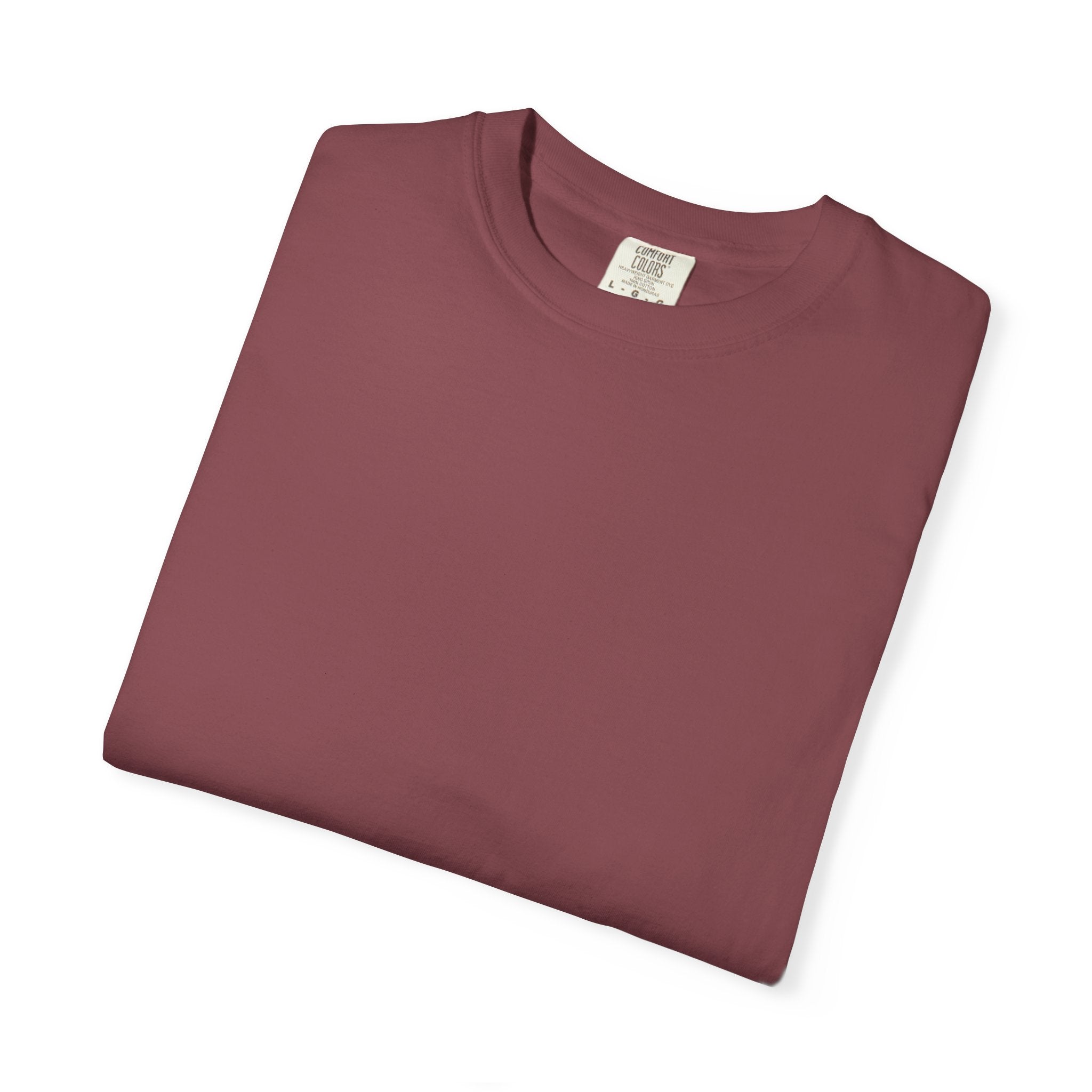 Folded maroon t-shirt with a label on a white background