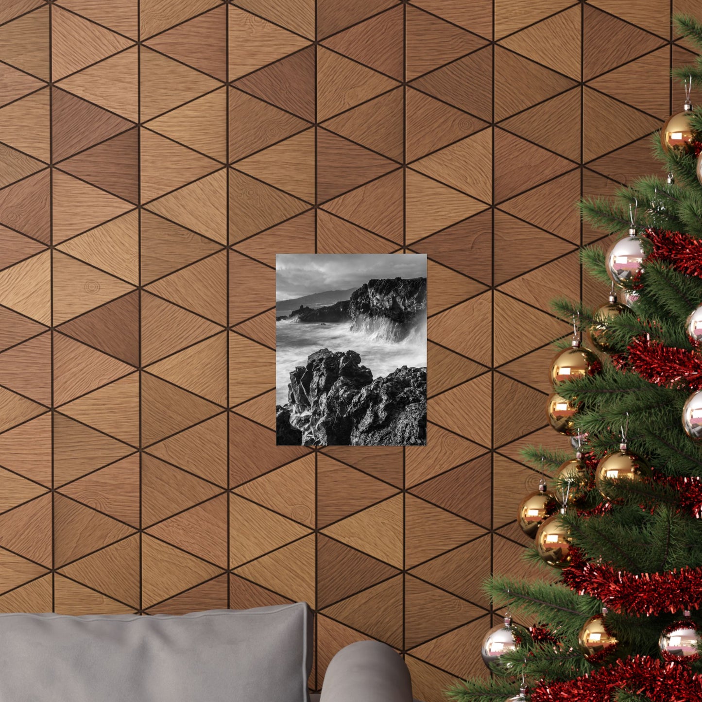 Wooden wall with geometric pattern, framed picture, and Christmas tree with decorations.
