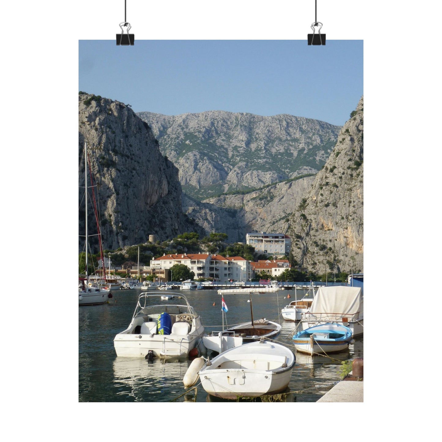 Harbor scene with boats and mountains in the background