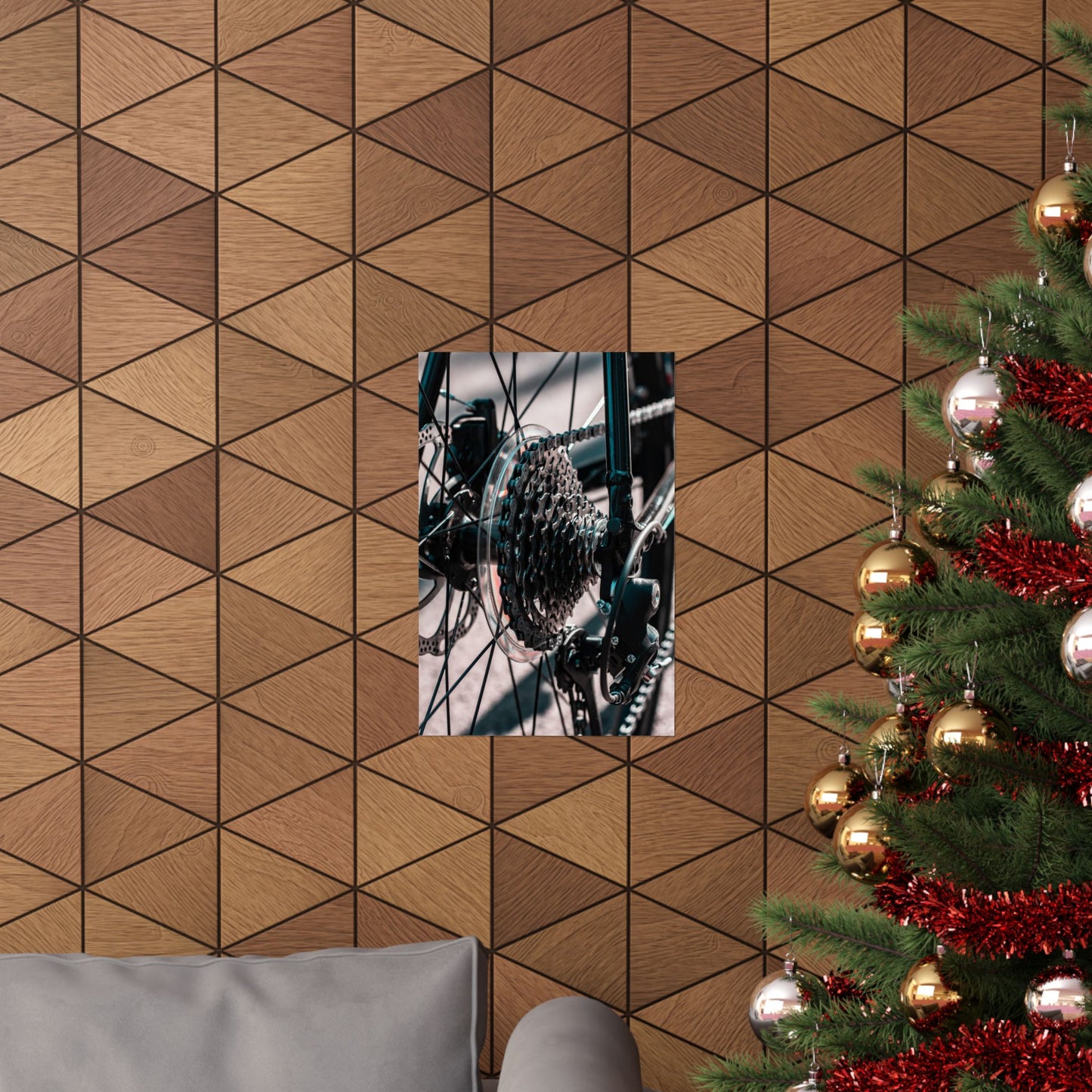 Wooden wall with geometric pattern, framed picture, and Christmas tree with decorations.