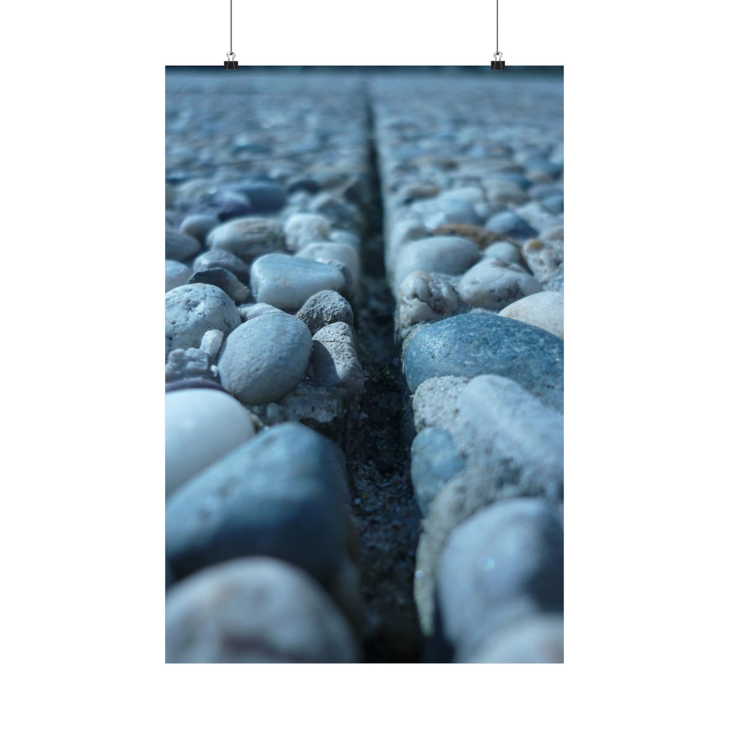 Close-up of pebbles with a crack running through them on a white background
