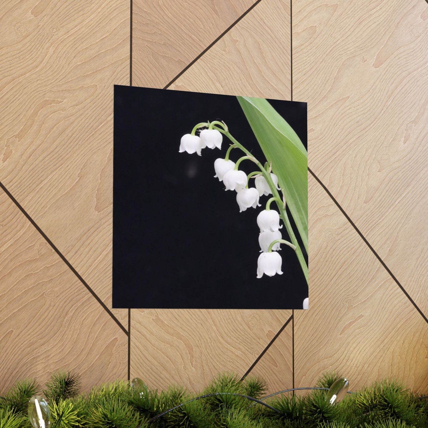 Framed picture of white flowers on a wooden wall