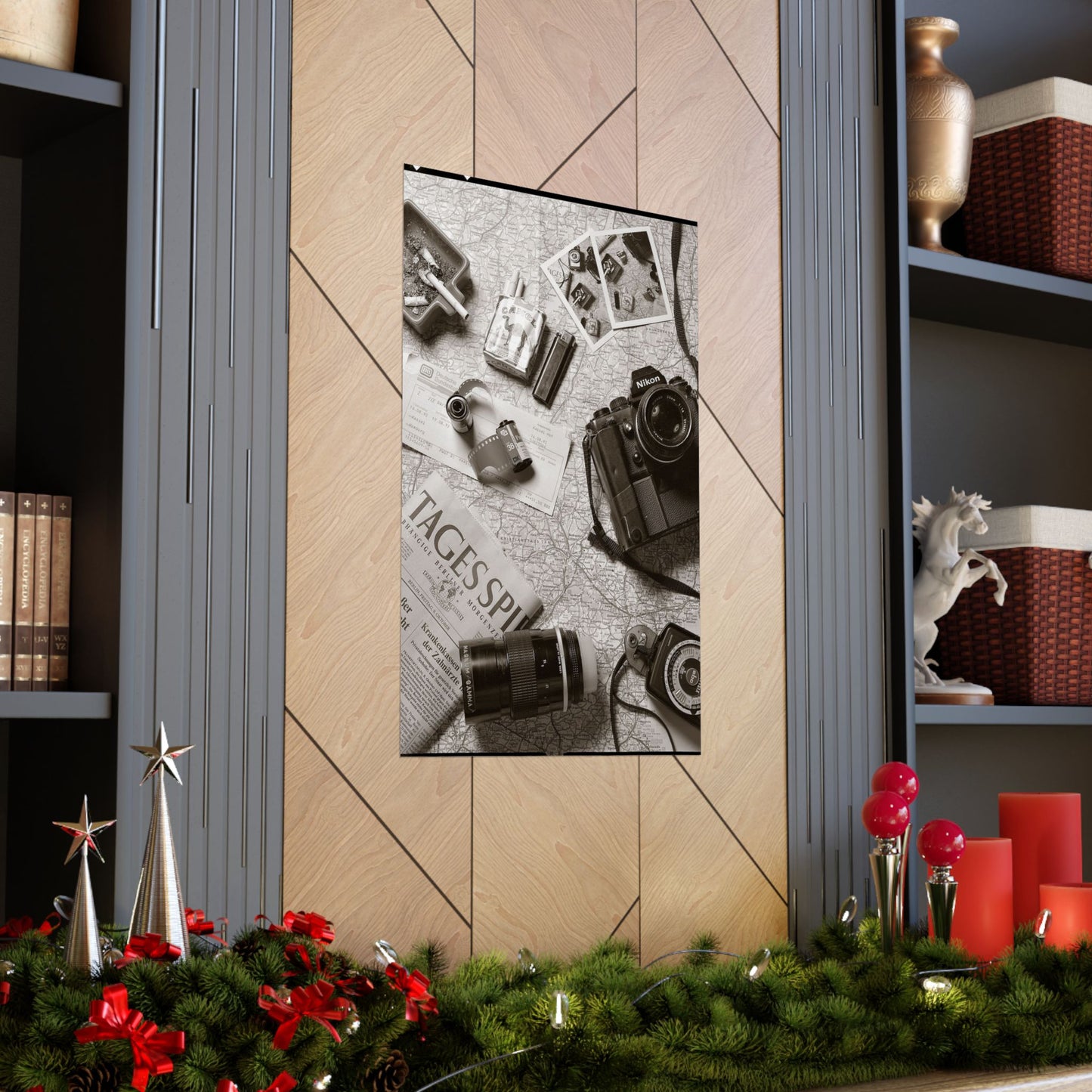 Decorative wall art with vintage cameras on a newspaper background, displayed on a wall with festive decorations at the bottom.