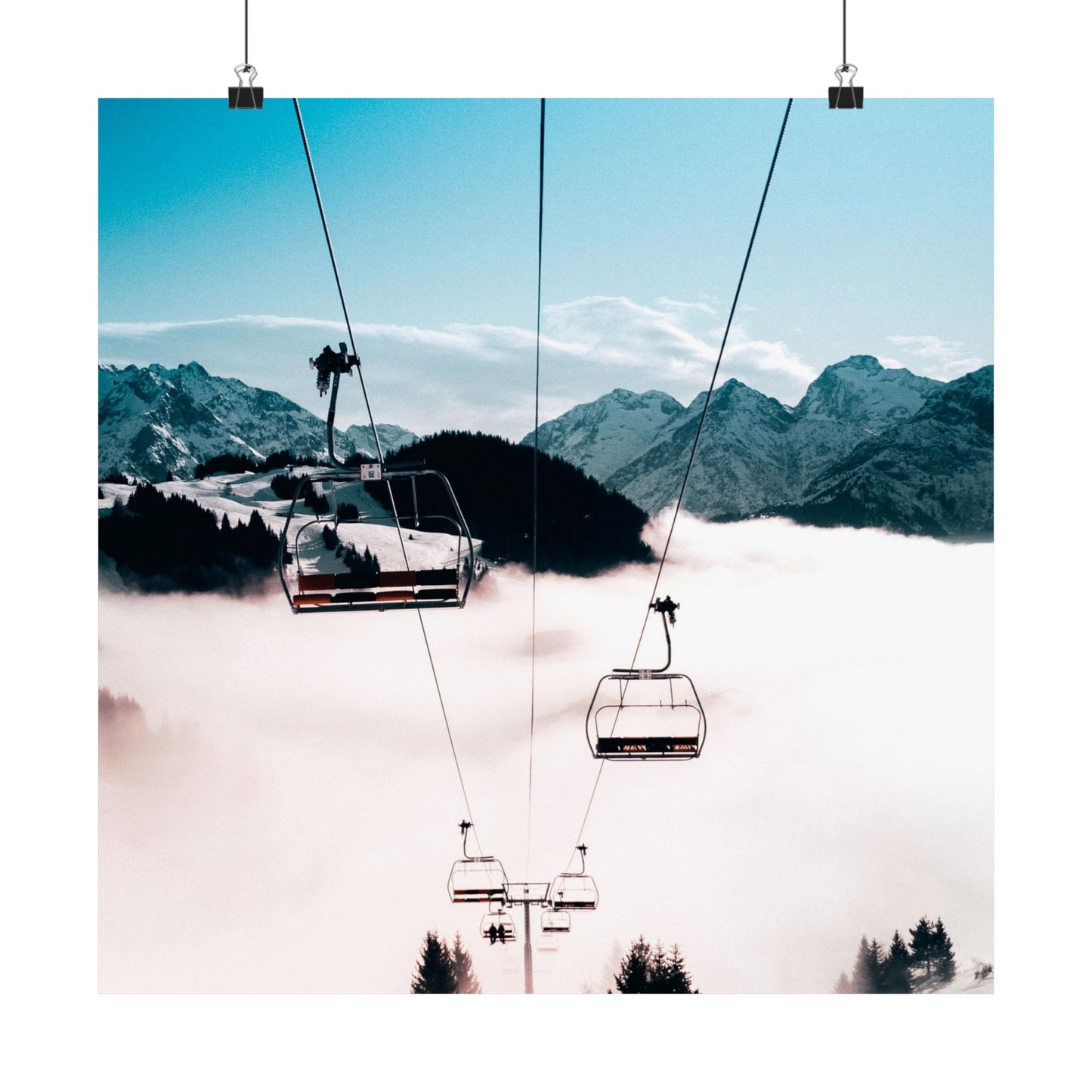 Ski lift with mountains and clouds in the background