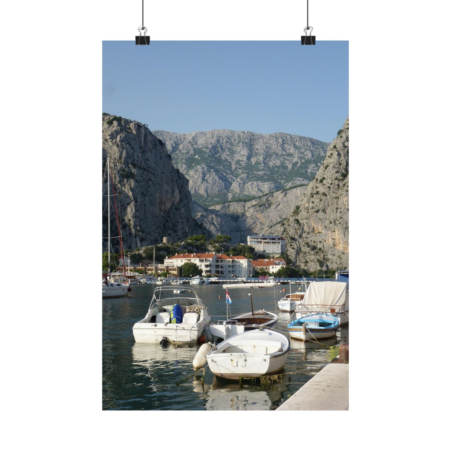 Harbor scene with boats and mountains in the background