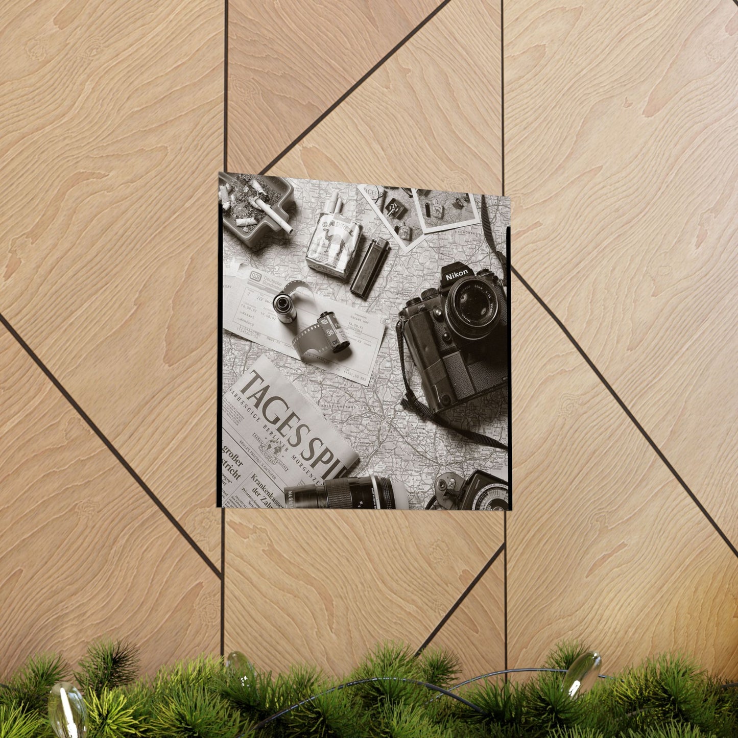 Poster with vintage camera and items on a map against a wooden background