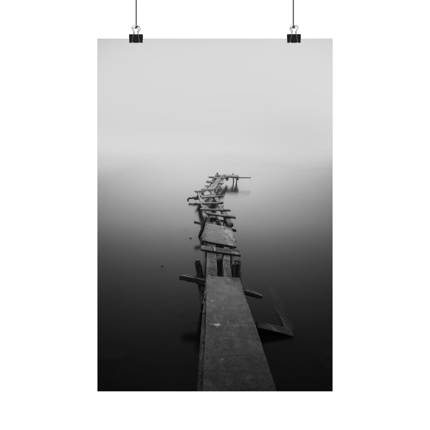 Long wooden pier extending into a foggy body of water