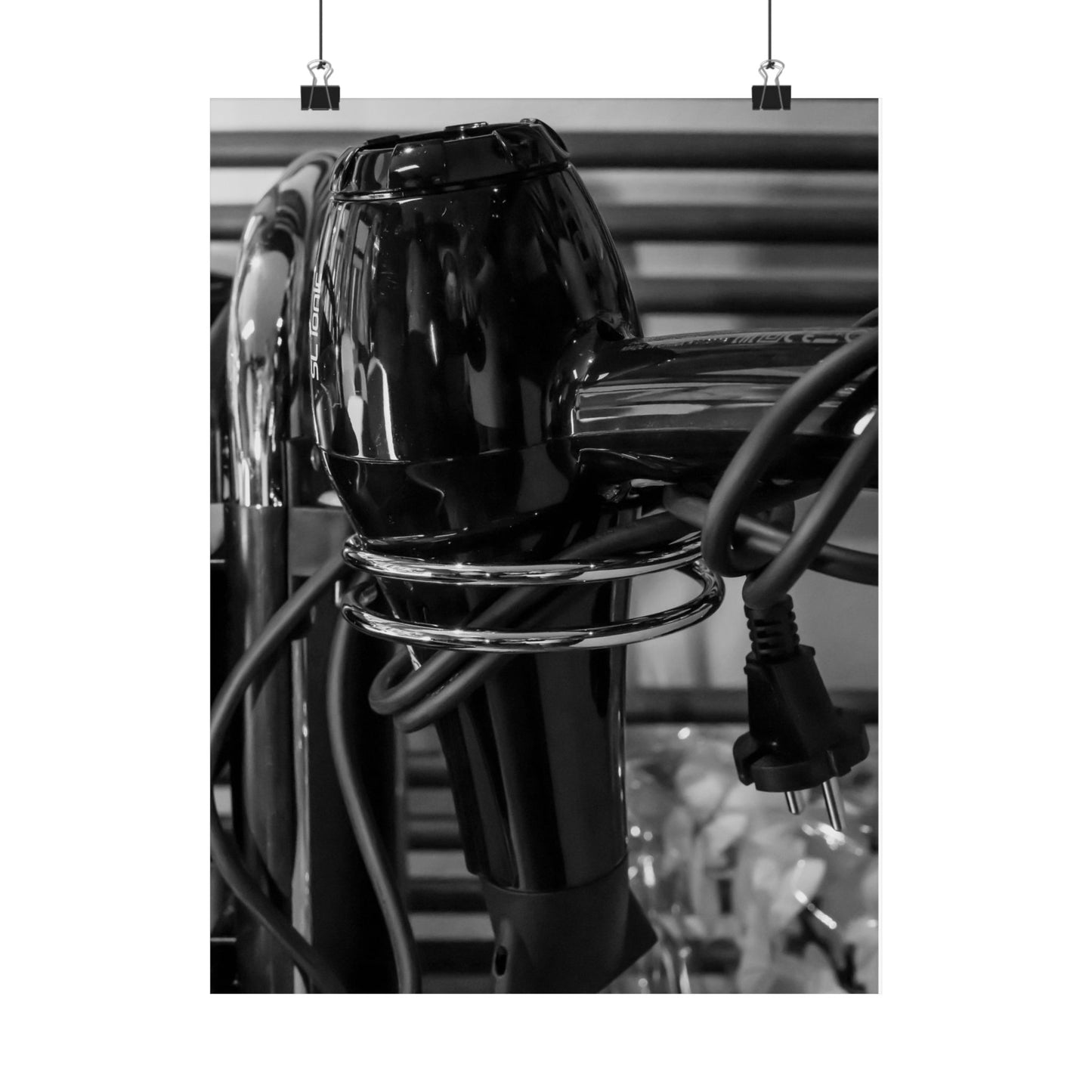 Black hair dryer with visible cord on a blurred background