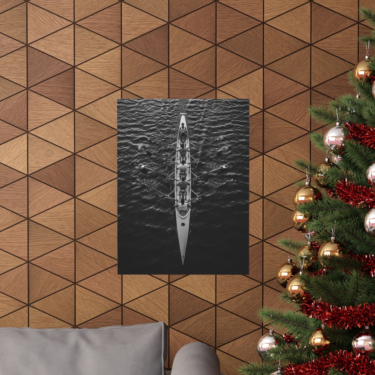 Poster of a kayak on water against a geometric wood-patterned wall with a Christmas tree to the right.