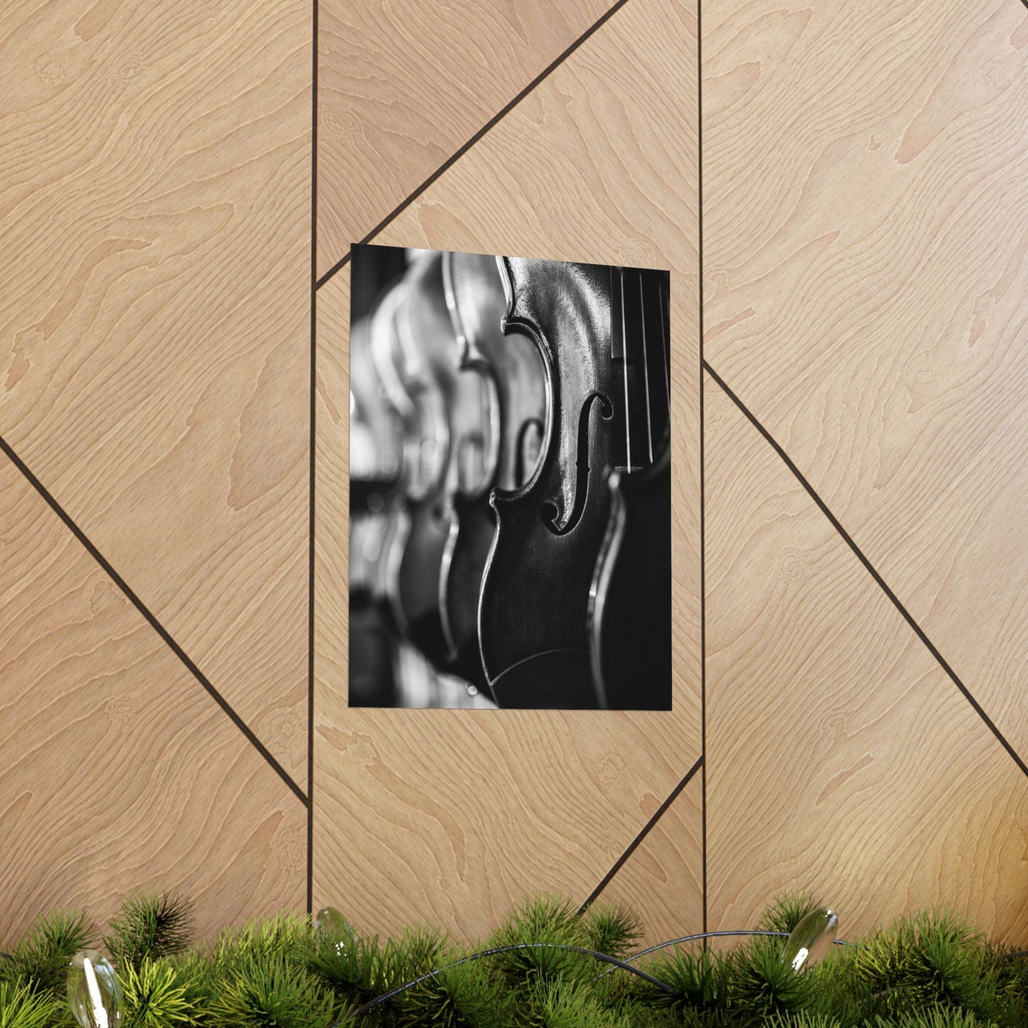 Framed black and white photo of a violin on a wooden wall with geometric patterns