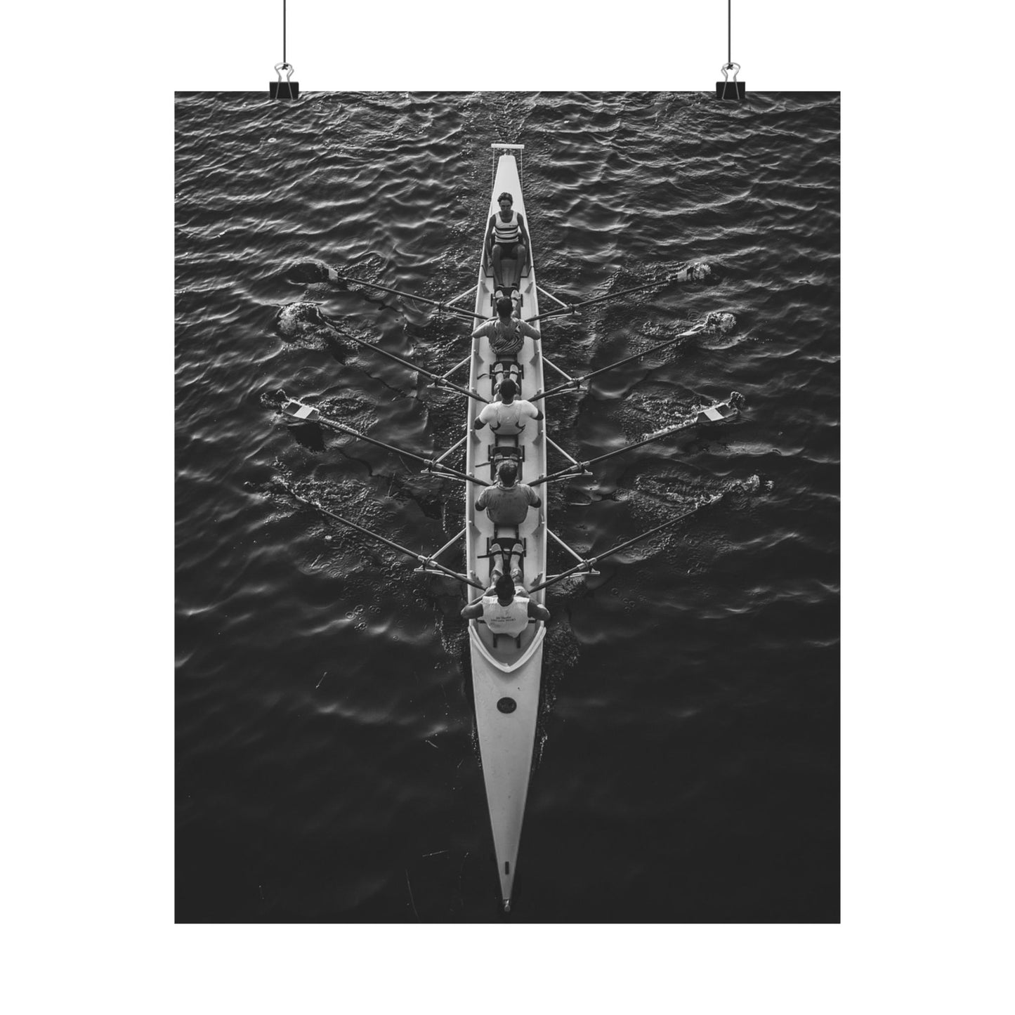 Aerial view of a rowing team in a boat on water