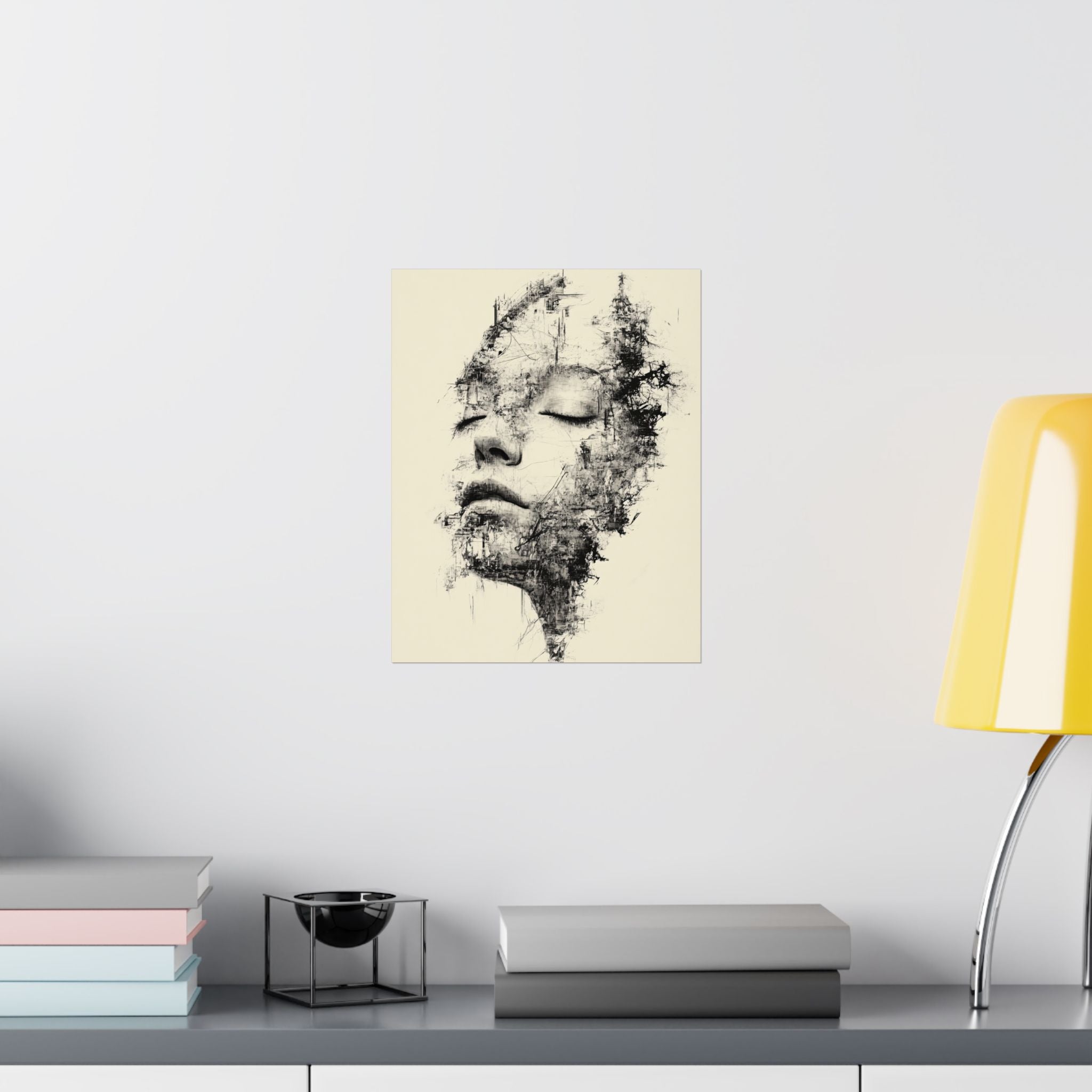 Abstract art print of a face on a wall above a shelf with books and a lamp.