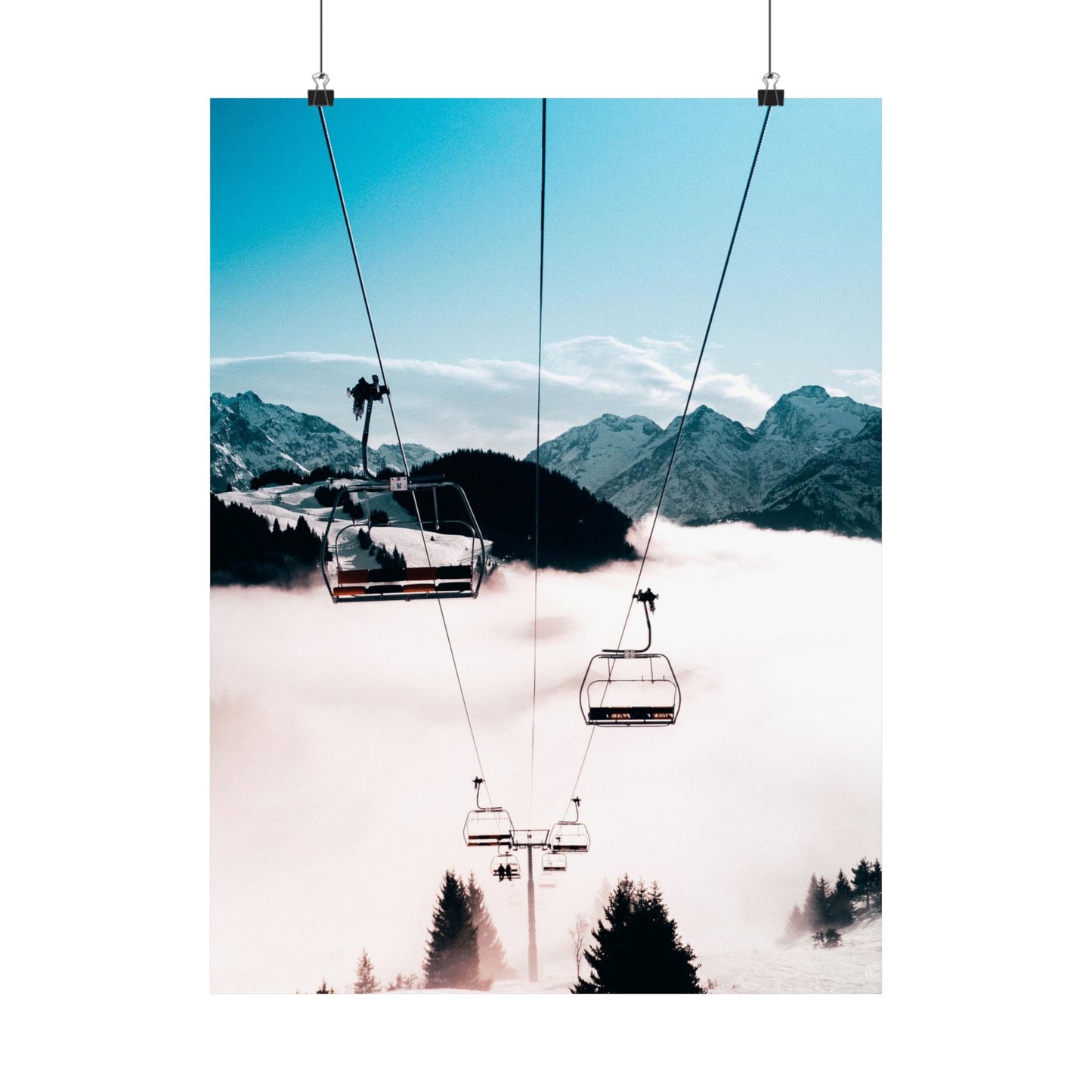 Ski lift with mountains and clouds in the background