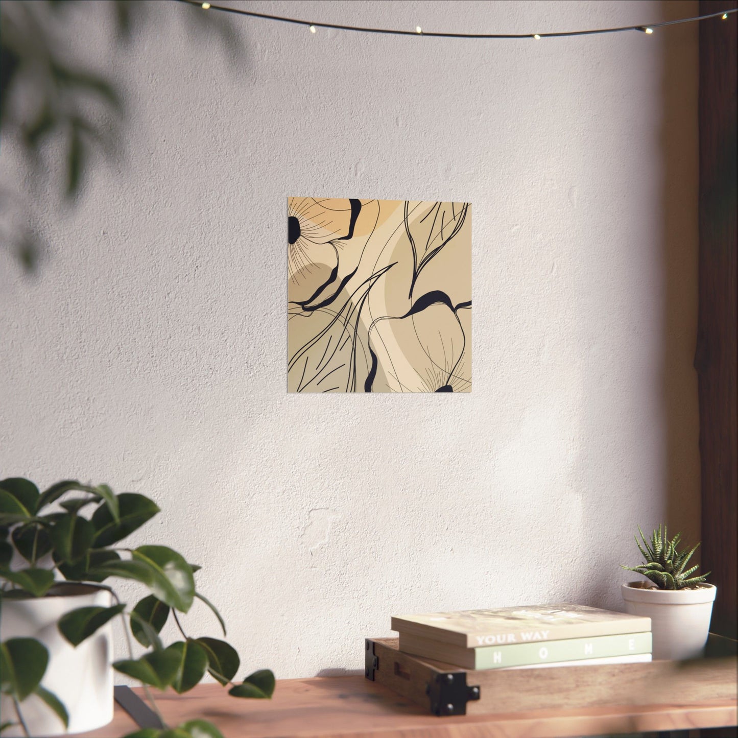 Abstract wall art on a white wall with a wooden table and plants in the foreground