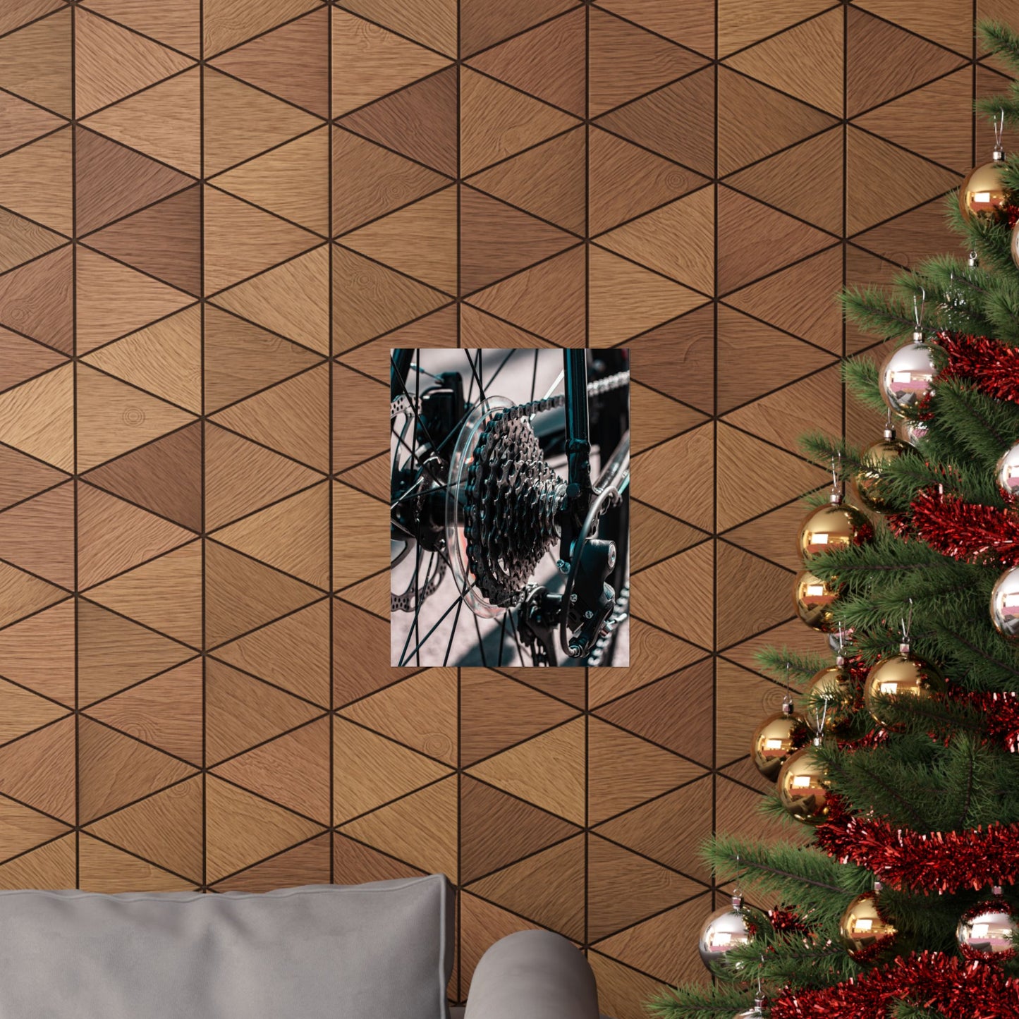 Wooden wall with geometric pattern, framed picture, and Christmas tree with decorations.