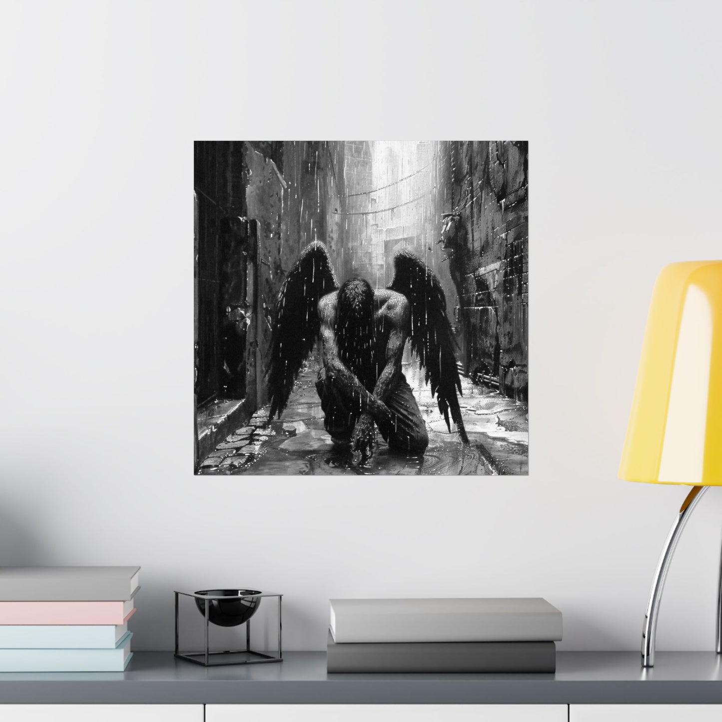 Art print of a winged figure in a dark, gothic setting on a wall above a shelf with books and decor.