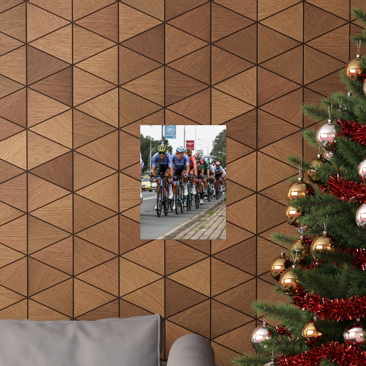 Wooden wall with geometric pattern, inset photo of cyclists, and Christmas tree with decorations.