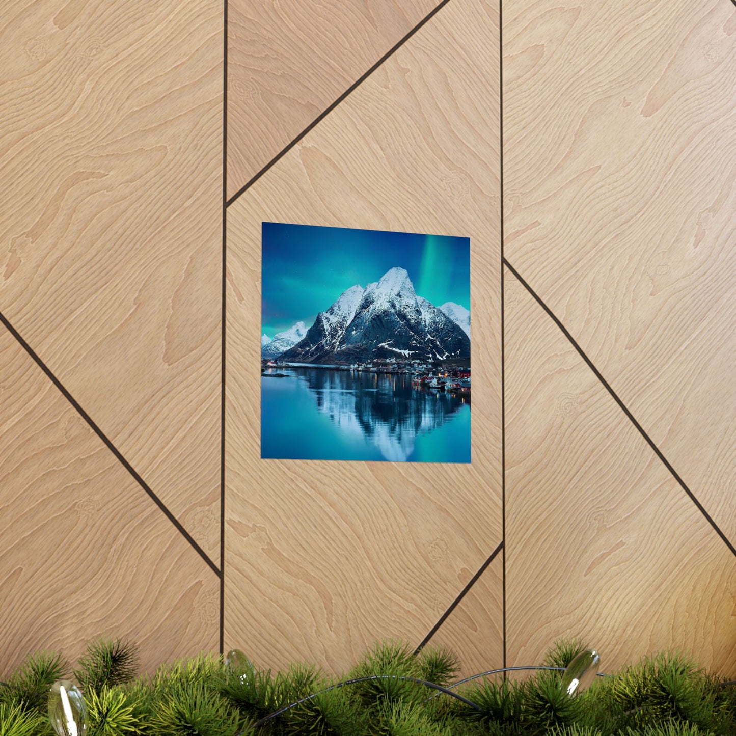 Framed photograph of a mountain landscape on a wooden wall.