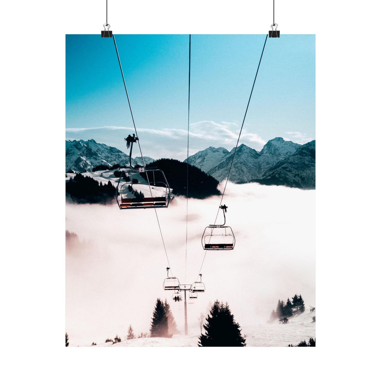 Ski lift with mountains and clouds in the background