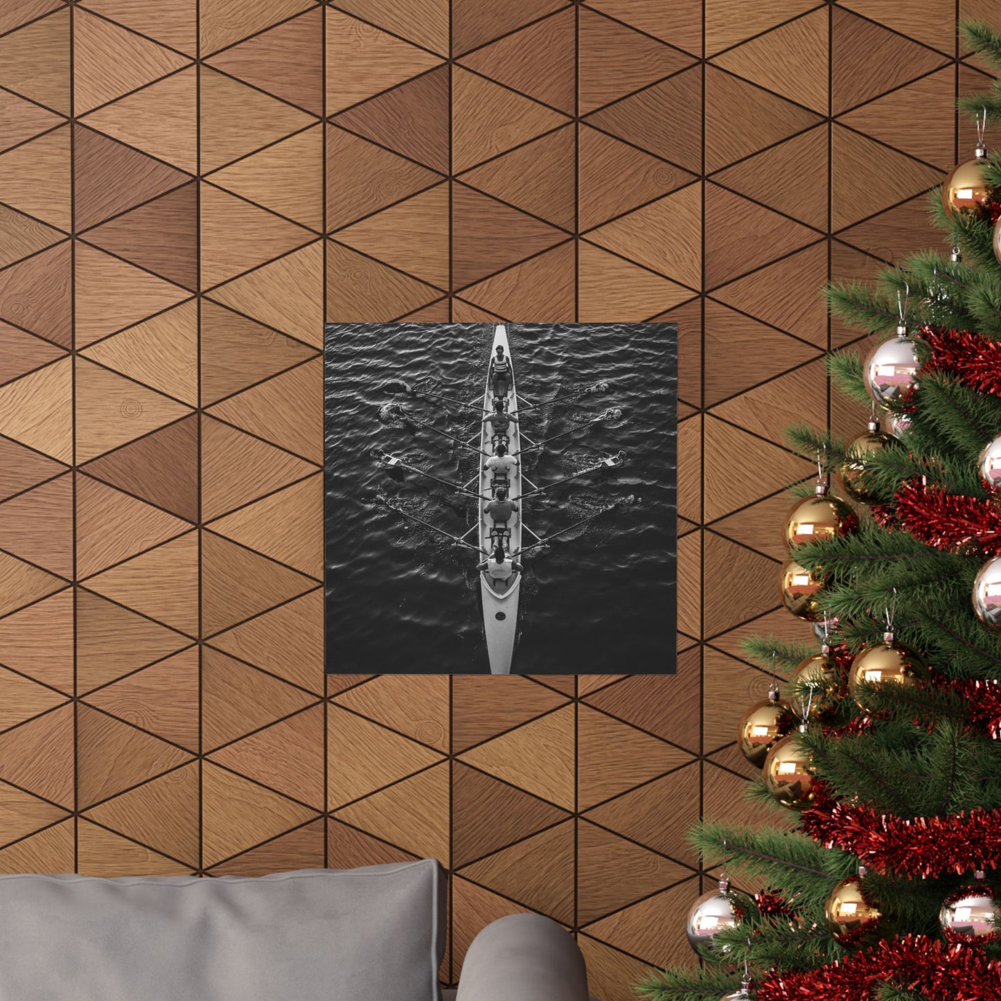Wooden wall with geometric pattern, framed picture of a boat, and Christmas tree with decorations.