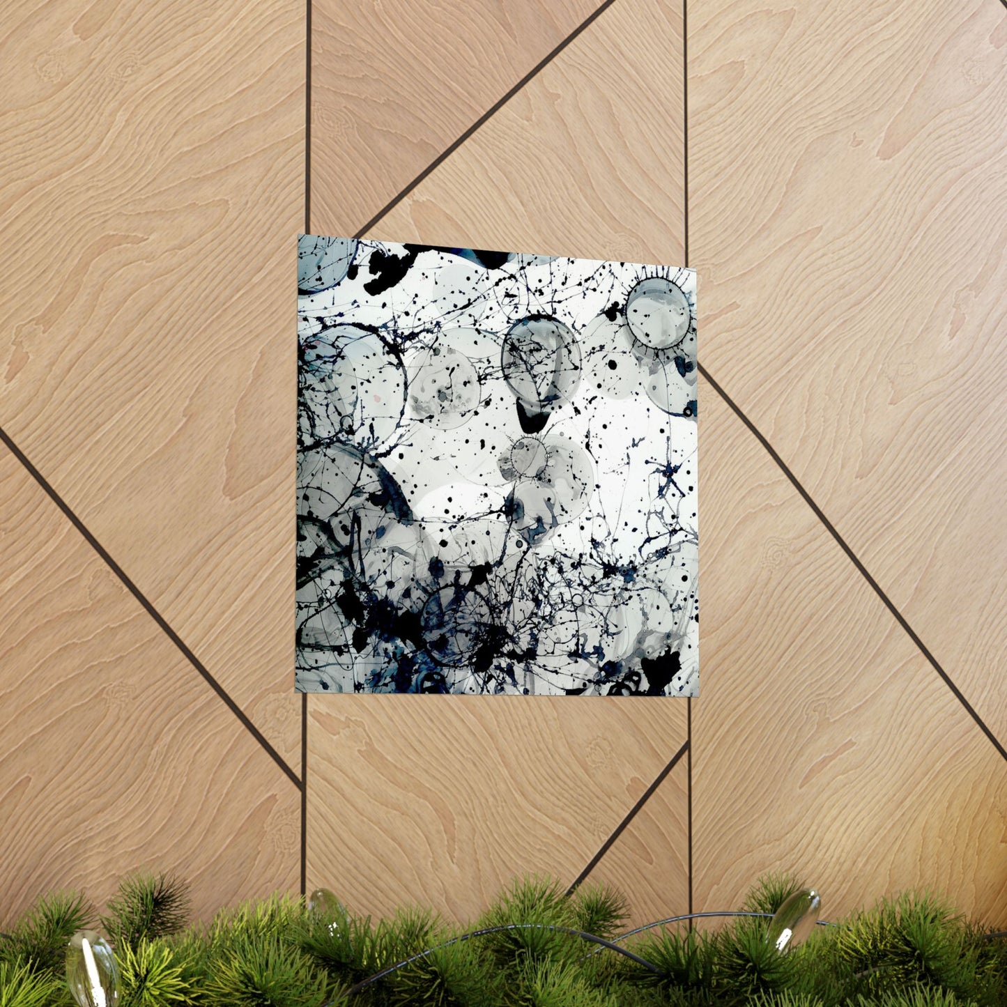 Abstract art print on a wooden panel with greenery at the bottom