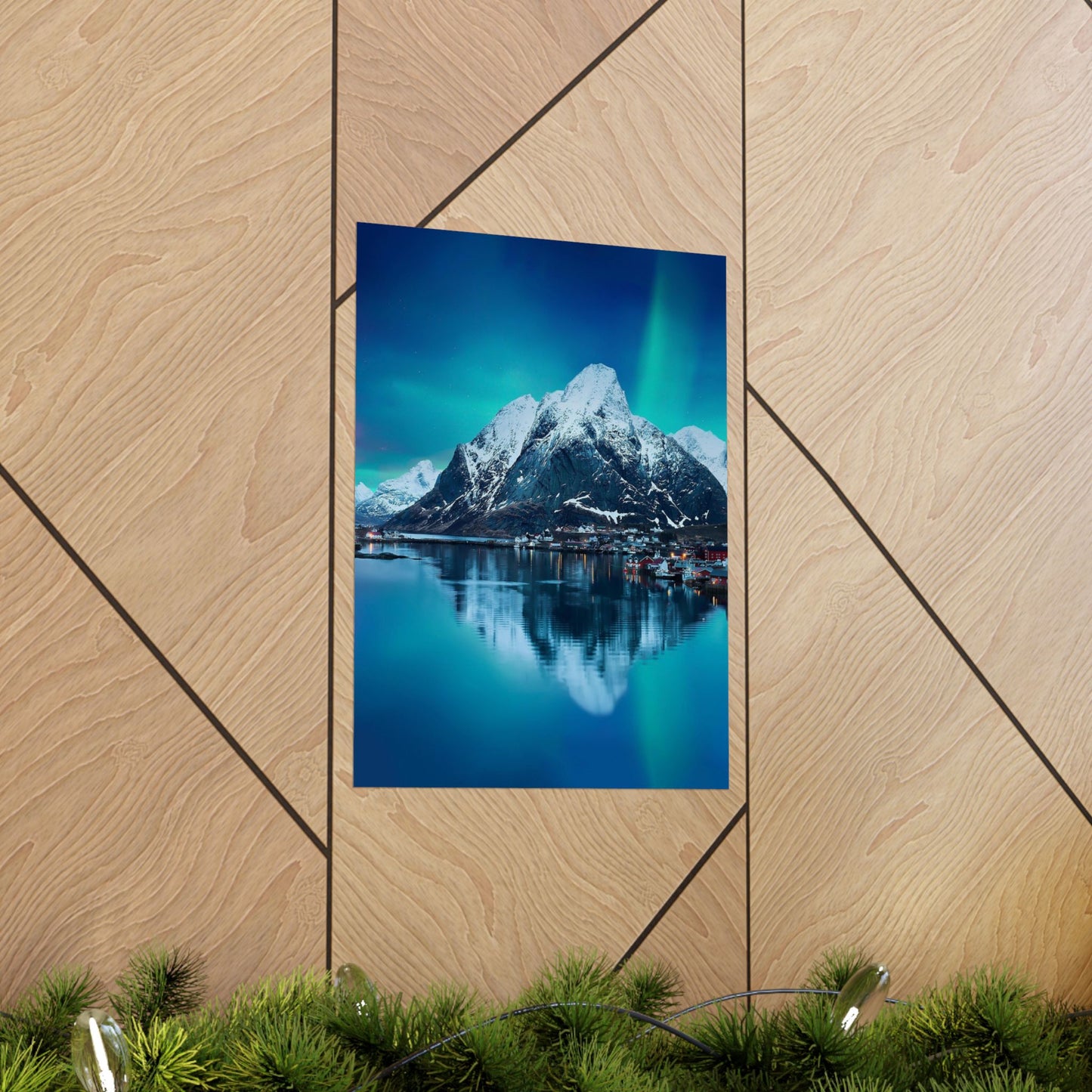 Framed photograph of a mountain landscape with a lake on a wooden wall.