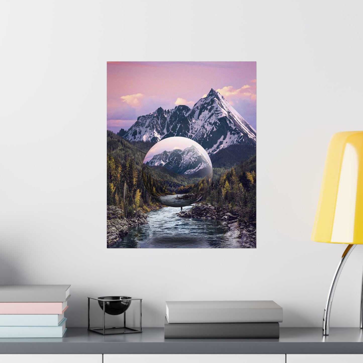 Framed artwork of a mountain landscape with a reflective lake on a white wall.