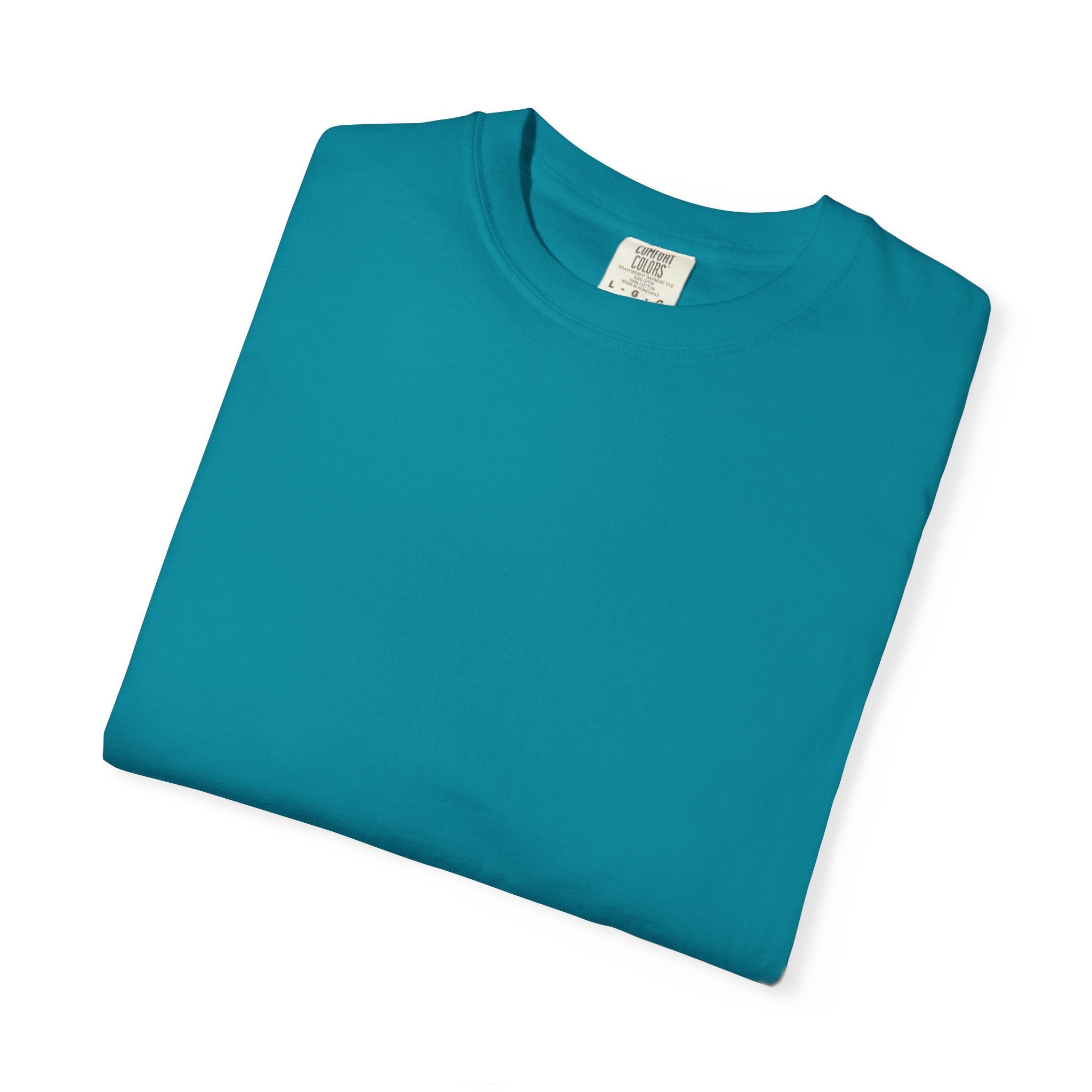 Folded teal t-shirt with a label on a white background