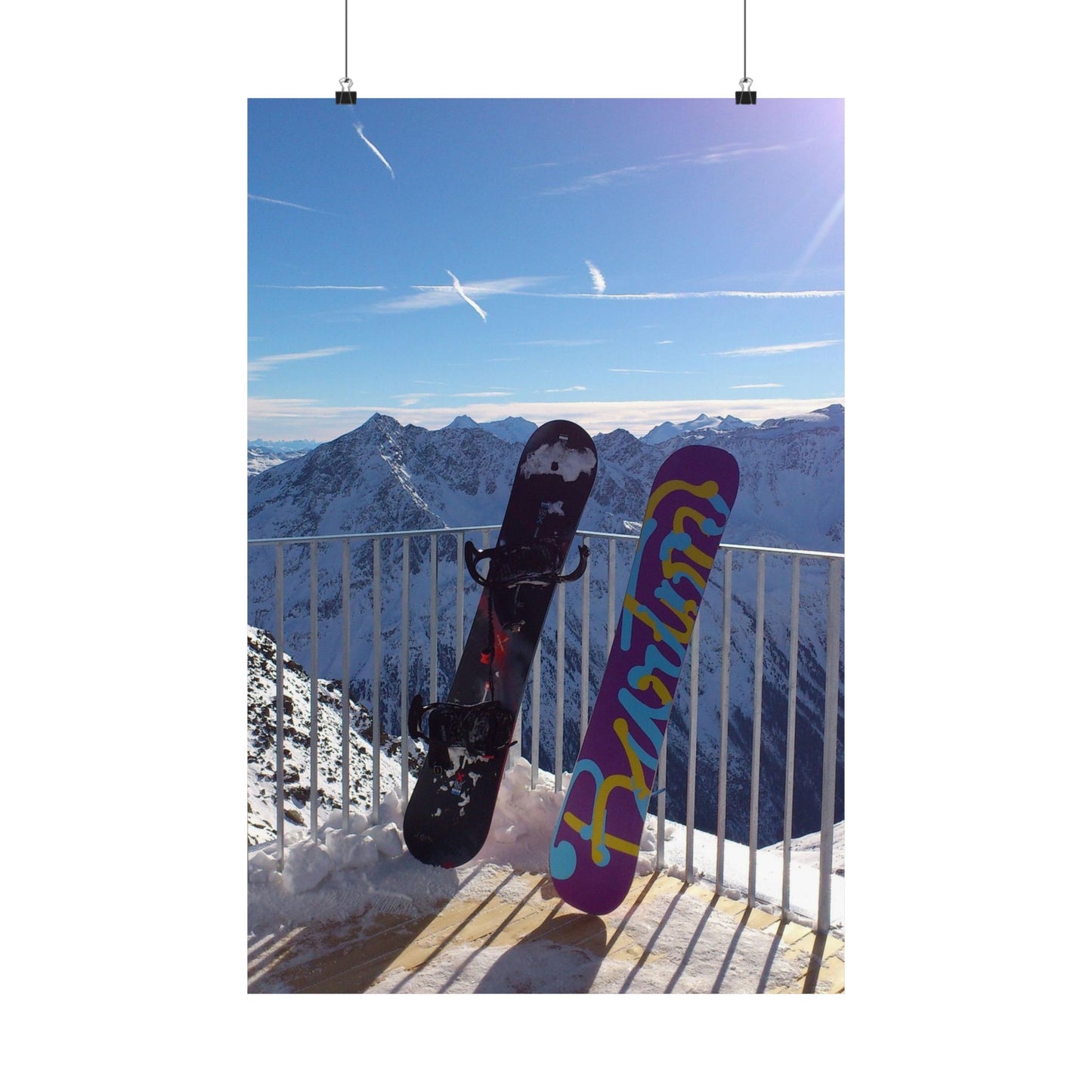 Two snowboards against a mountainous background