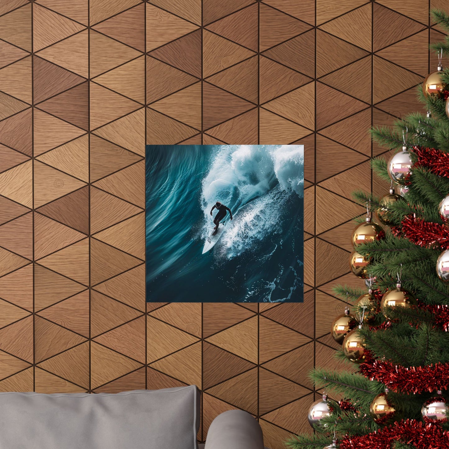 Poster of a surfer on a wave hanging on a geometric-patterned wall next to a decorated Christmas tree.