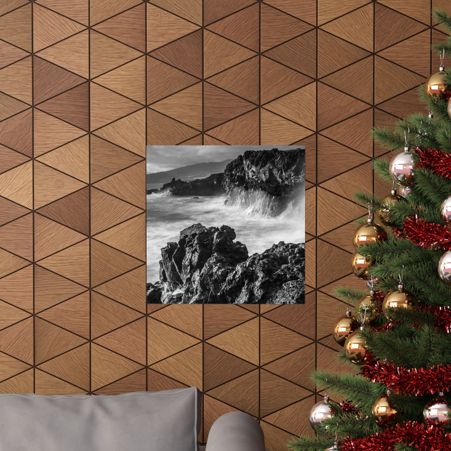 Wooden wall with geometric pattern, framed black and white photo of rocks, and decorated Christmas tree.