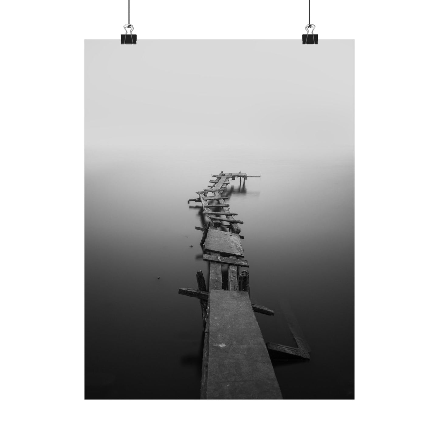 Wooden pier extending into a foggy body of water