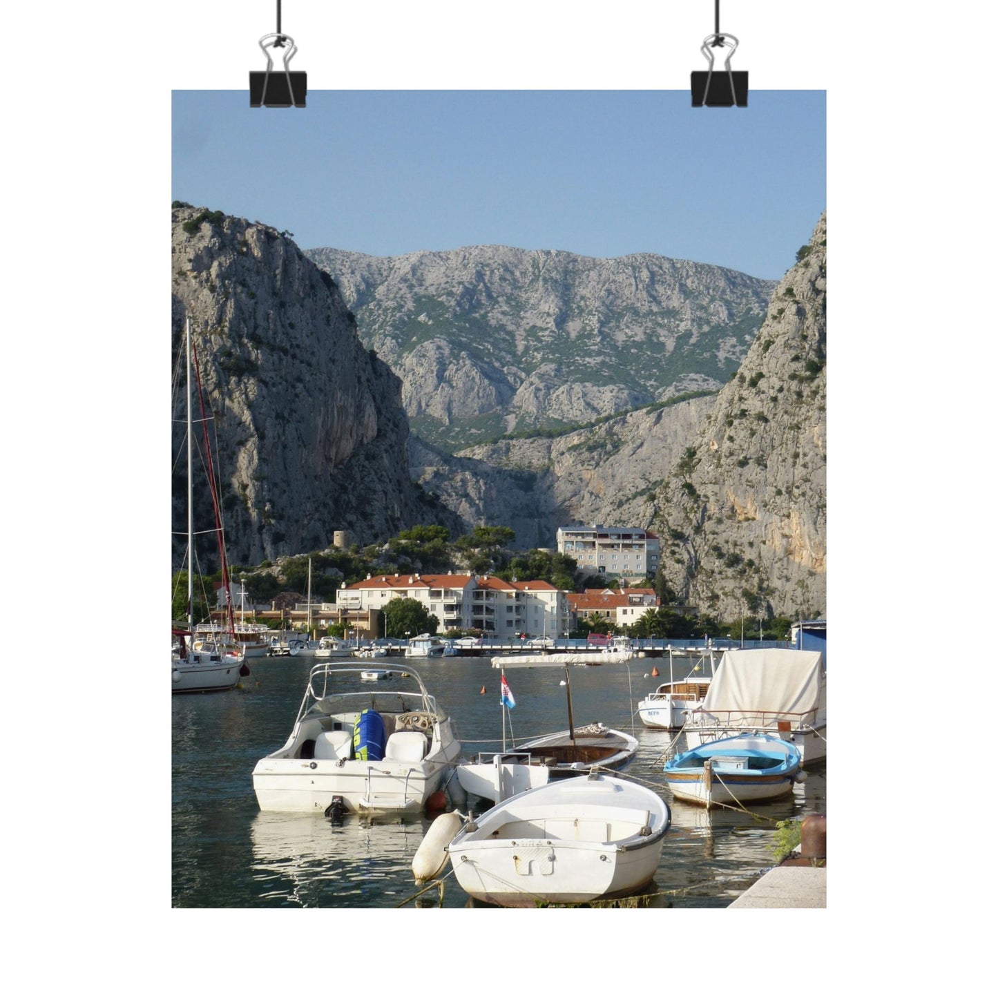 Harbor scene with boats and mountains in the background