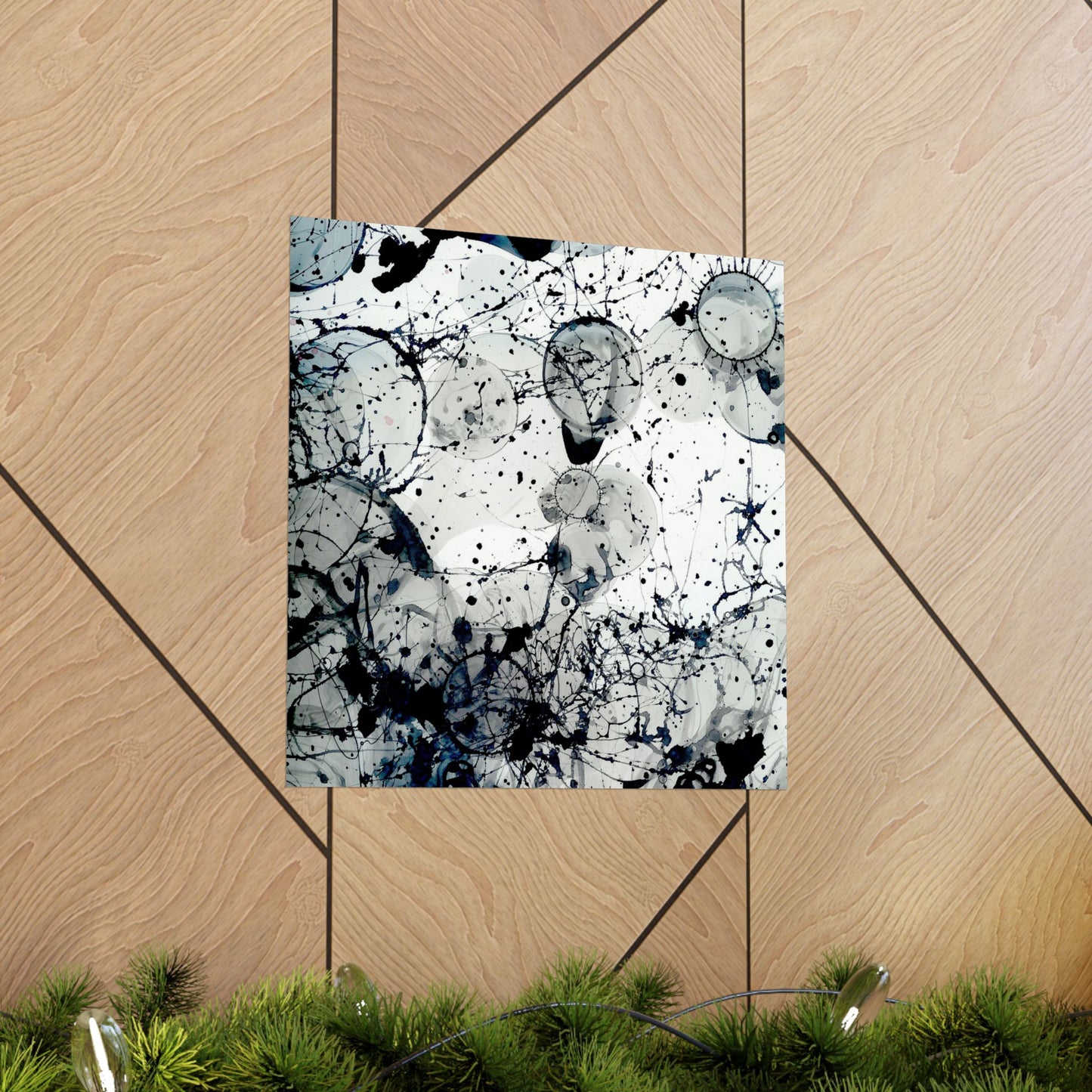 Abstract art print with black and white splashes on a wooden floor