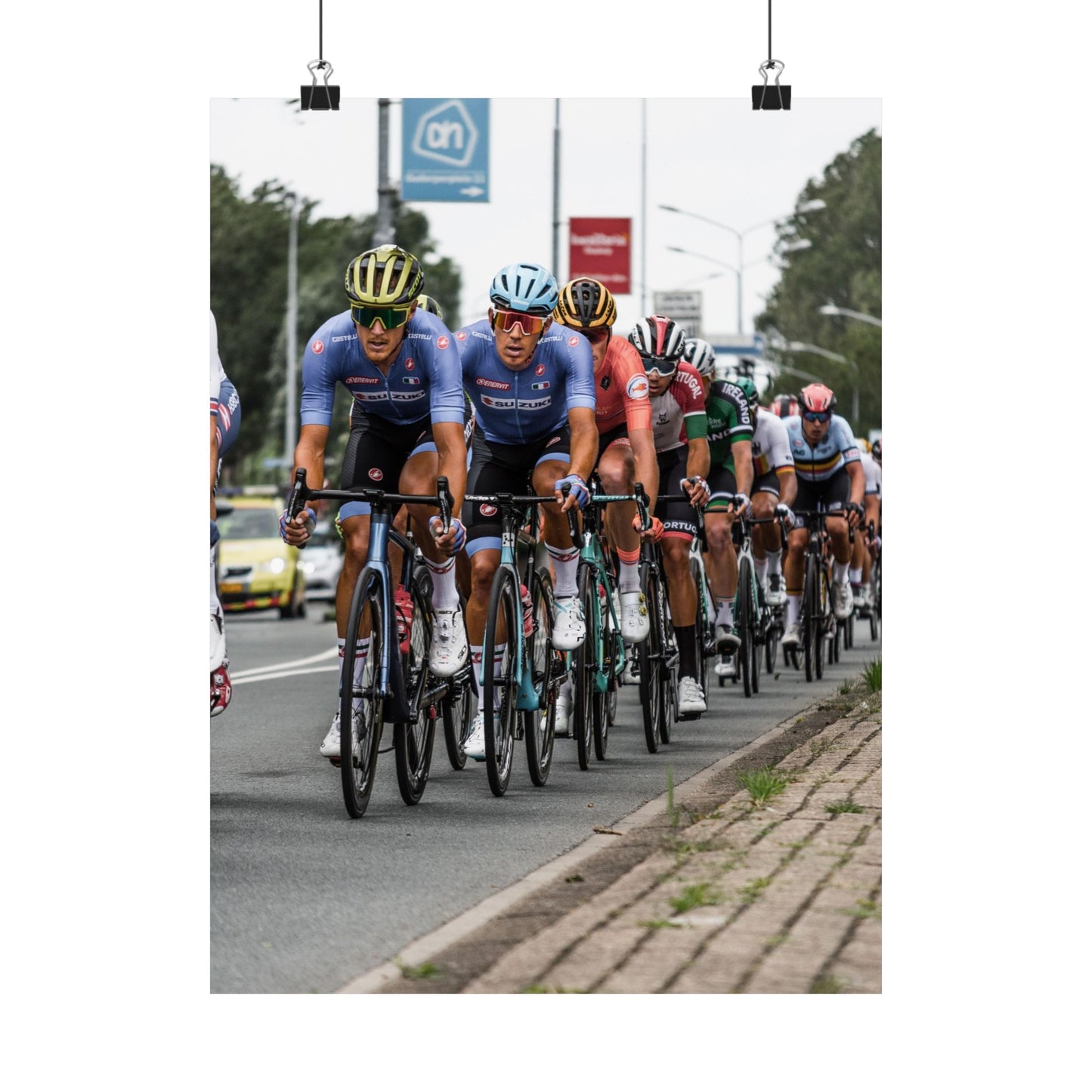 Cycling race with cyclists in blue jerseys on a road.