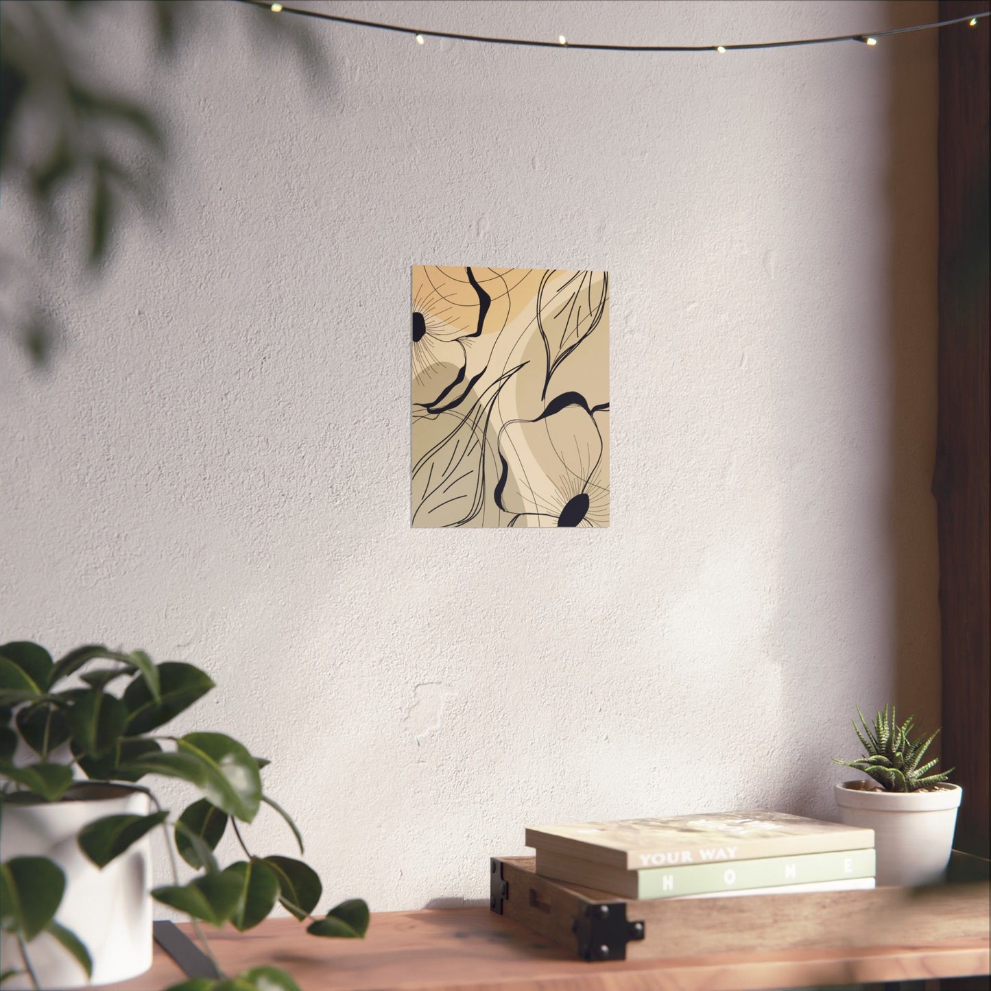 Abstract wall art on a white wall with a wooden table and plants below.