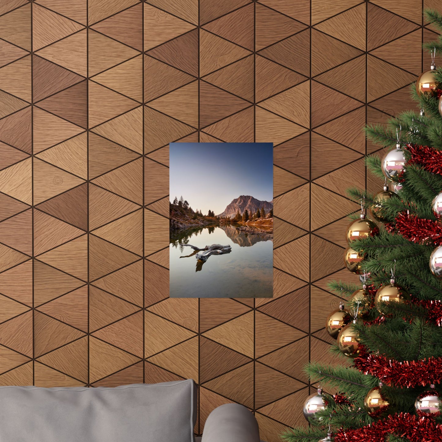 Decorative wall with geometric pattern, framed landscape print, and Christmas tree.