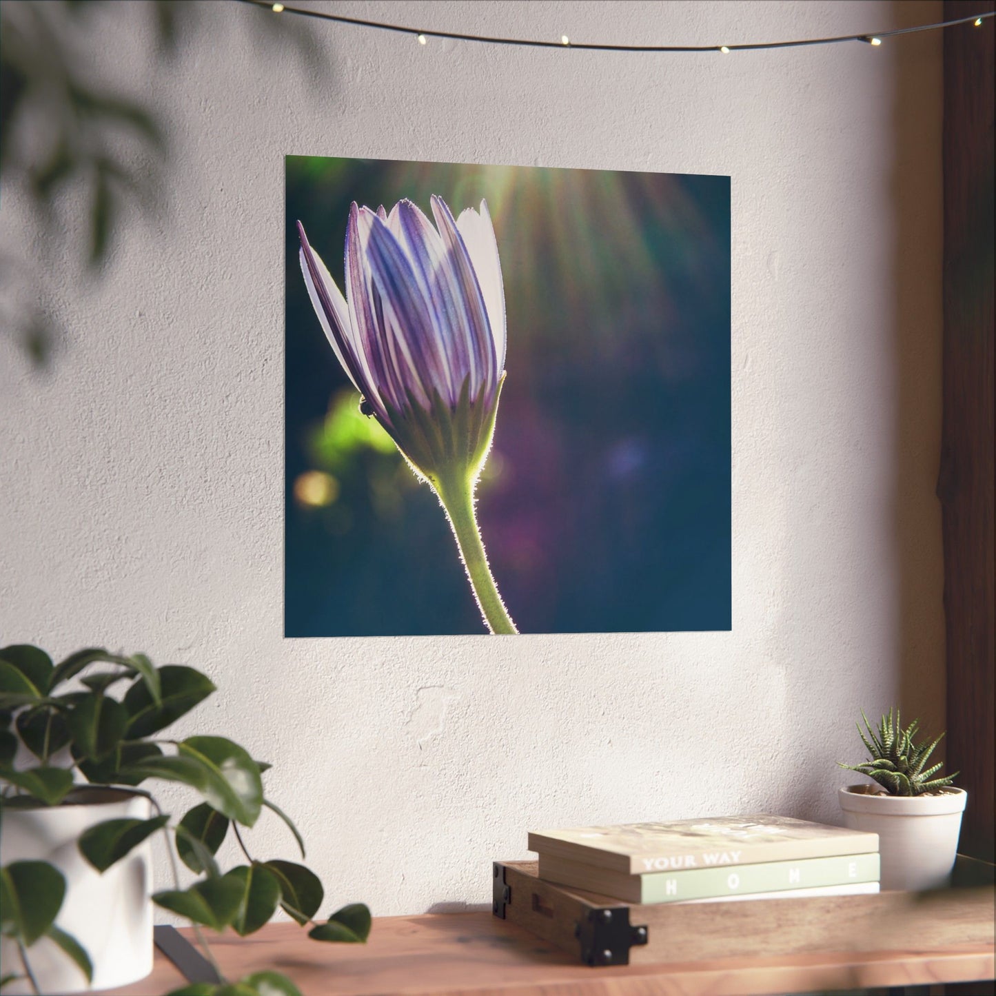Flower poster on a wall with a desk and plants below