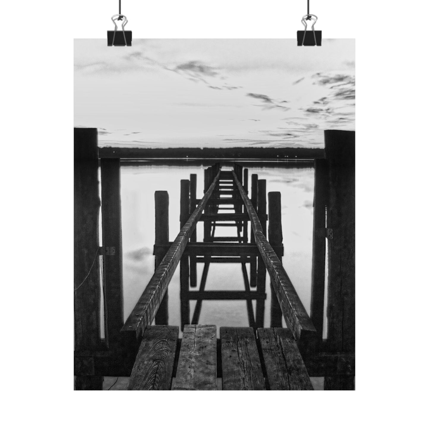Black and white photo of a wooden pier extending into water