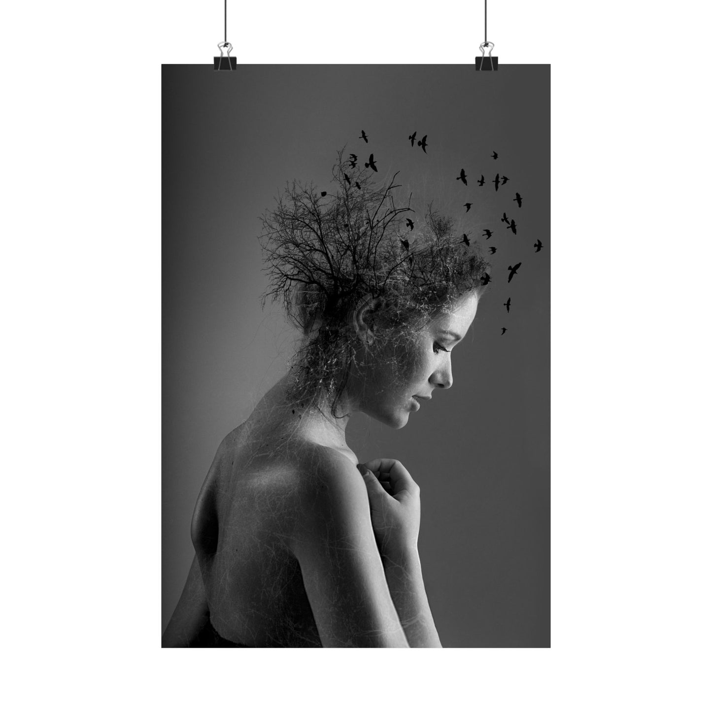 Black and white art print of a woman with birds in her hair on a dark background