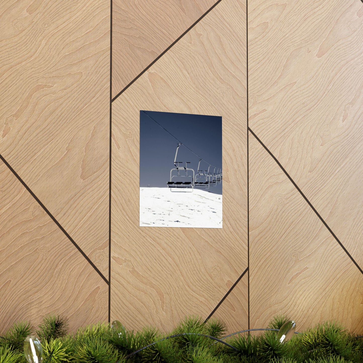 Ski lift chair against a blue sky on a wooden wall with geometric patterns