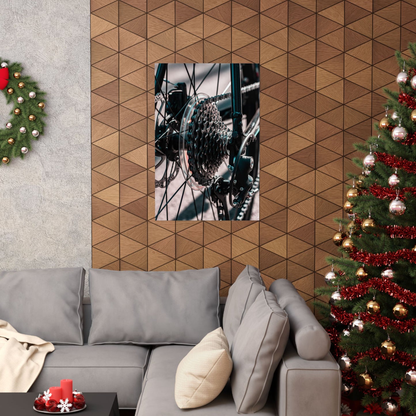 Living room with a gray sofa, Christmas tree, and geometric wall design.