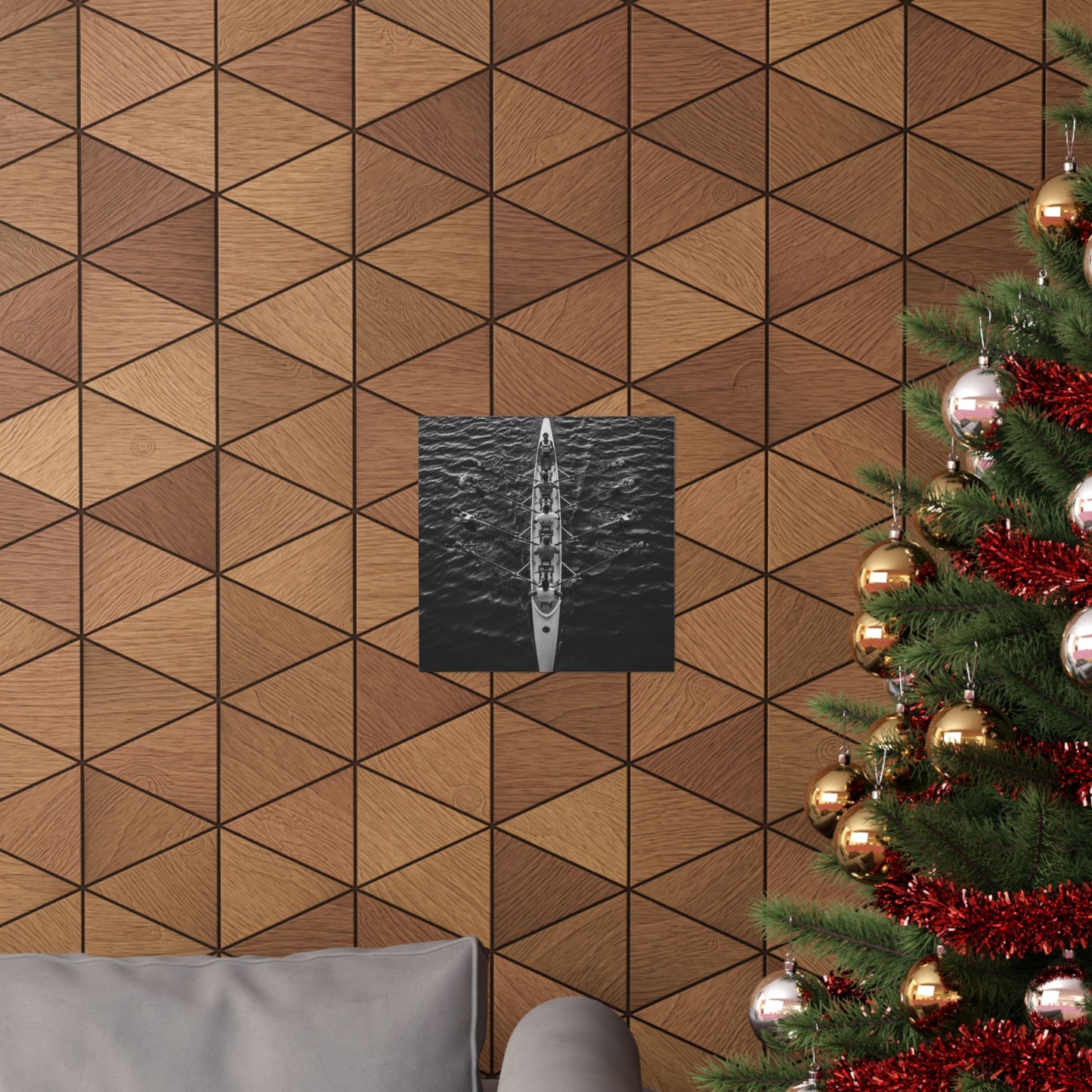 Wooden wall with geometric pattern, framed picture, and Christmas tree with decorations.